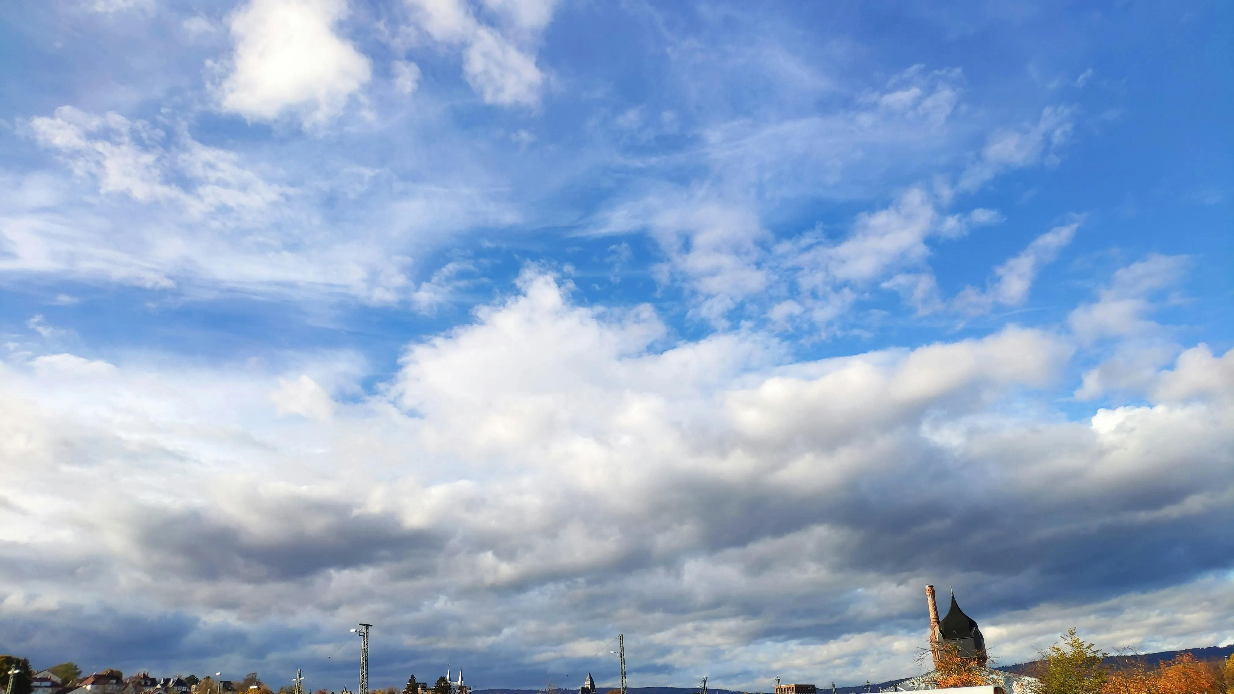 Expansive Landscape with Blue Sky and Soft White Clouds