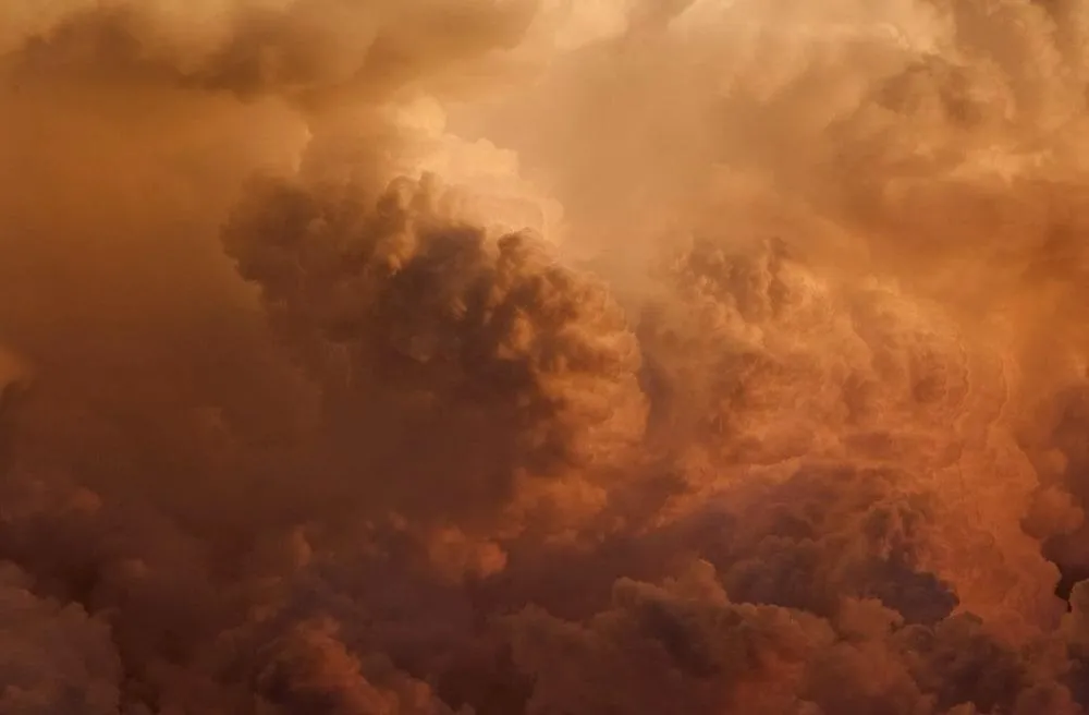 Fiery Orange Storm Clouds Over Open Horizon Line Image