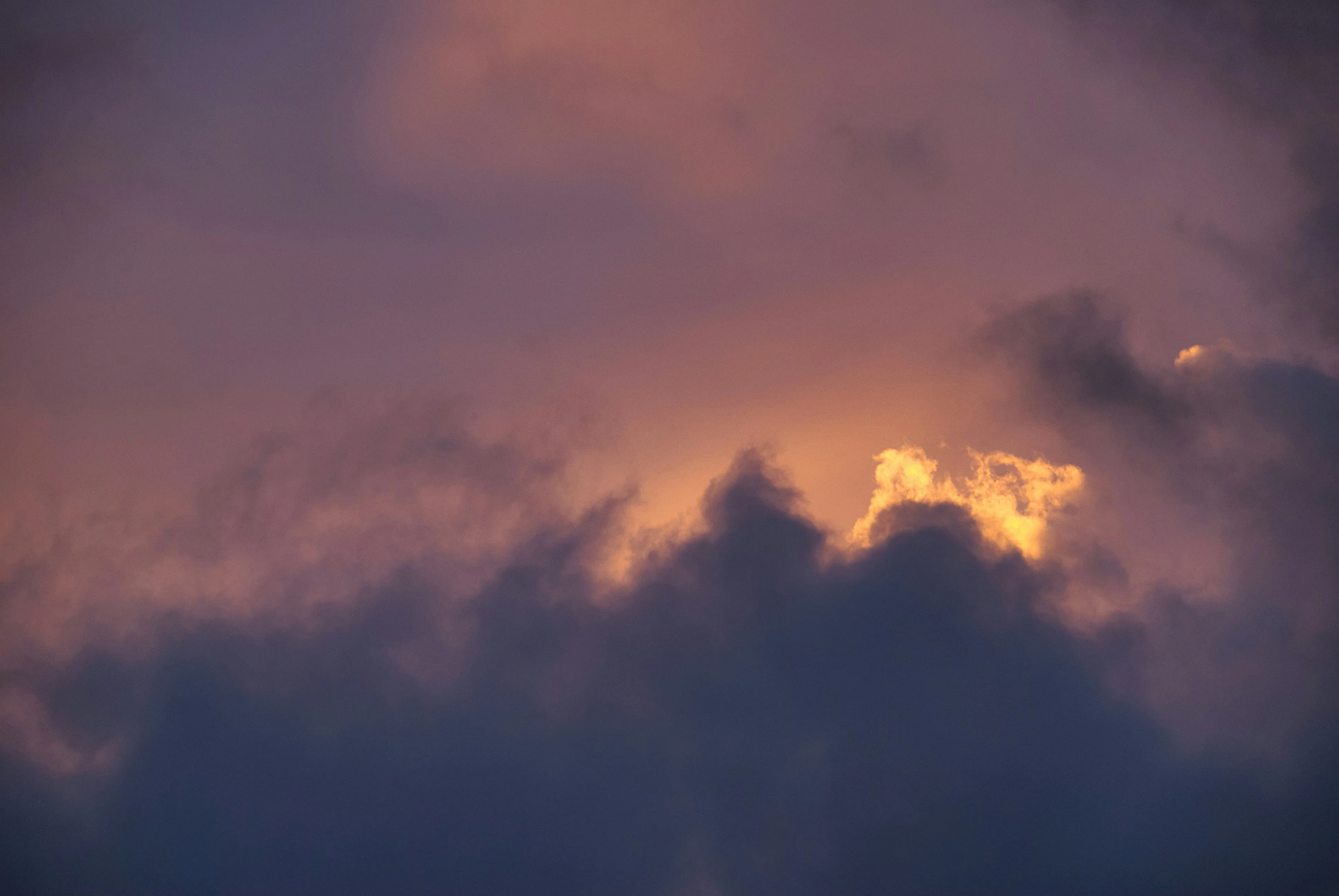 Fiery Orange Sunset Over Layers of Thunderclouds Image