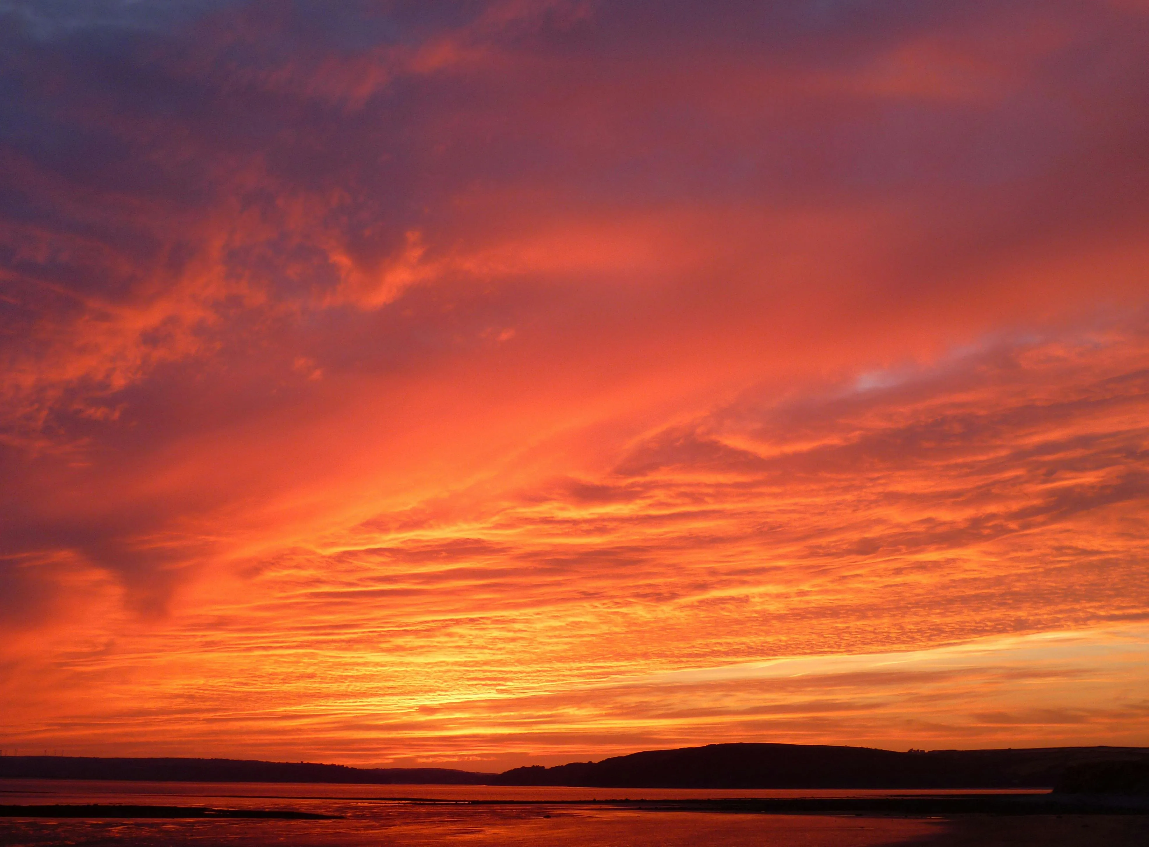 Fiery Red and Orange Sunset with Dramatic Clouds Image