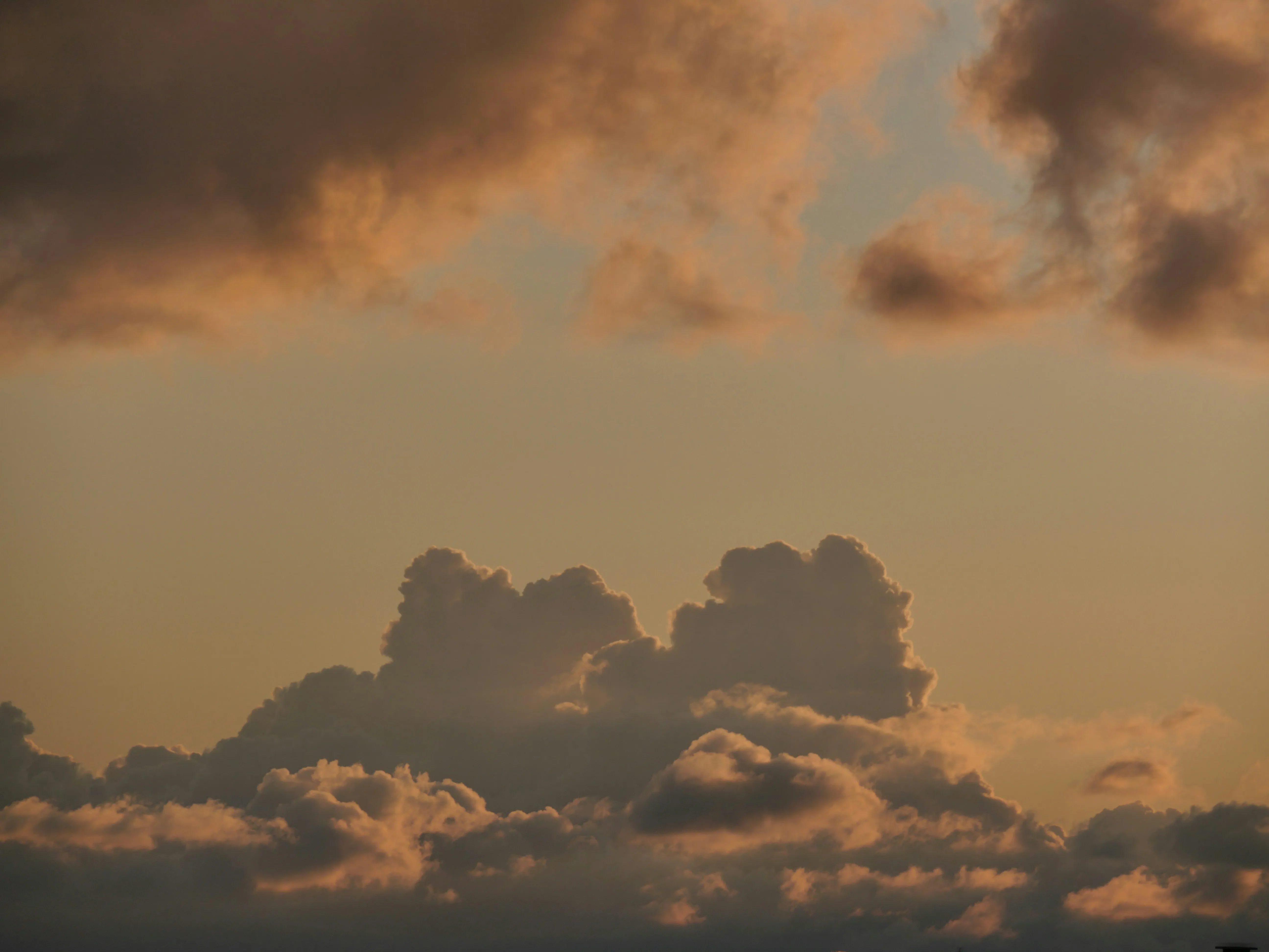 Fiery Sunset Behind Thick Layered Cumulus Clouds Wallpaper