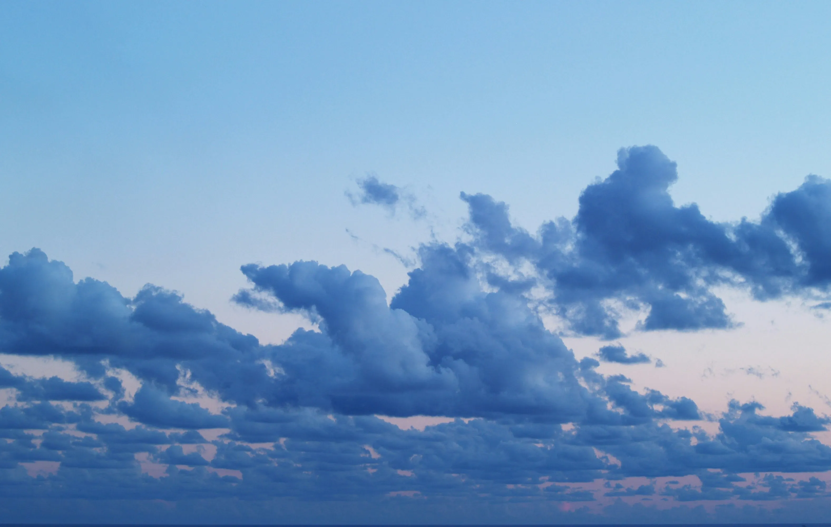 Fluffy Clouds Floating High Over Bright Blue Sky Image