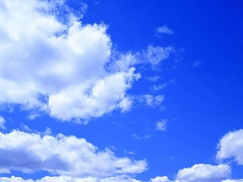 Fluffy Clouds Scattered in Vibrant Blue Daytime Sky