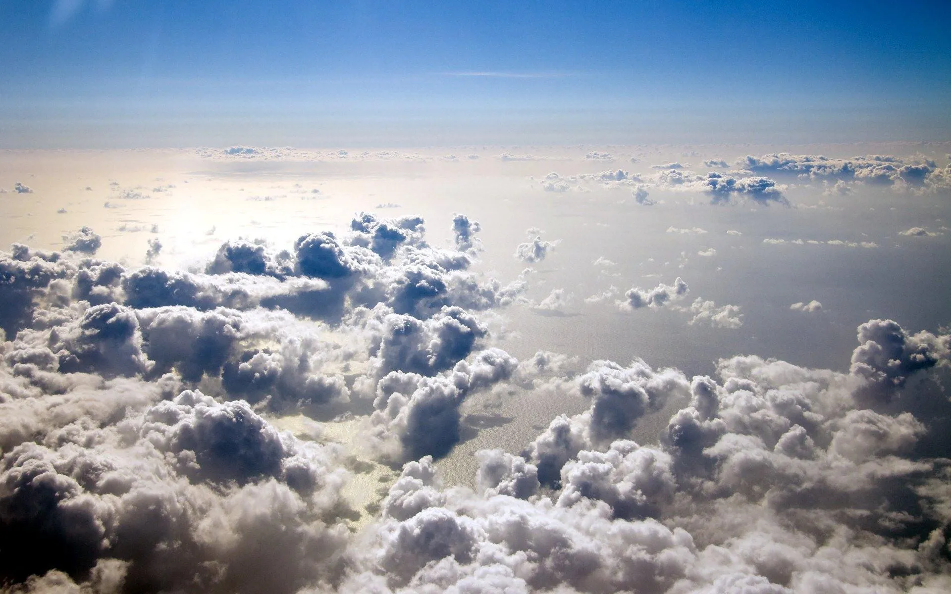 Fluffy Clouds Seen From an Airplane Window at High Altitude
