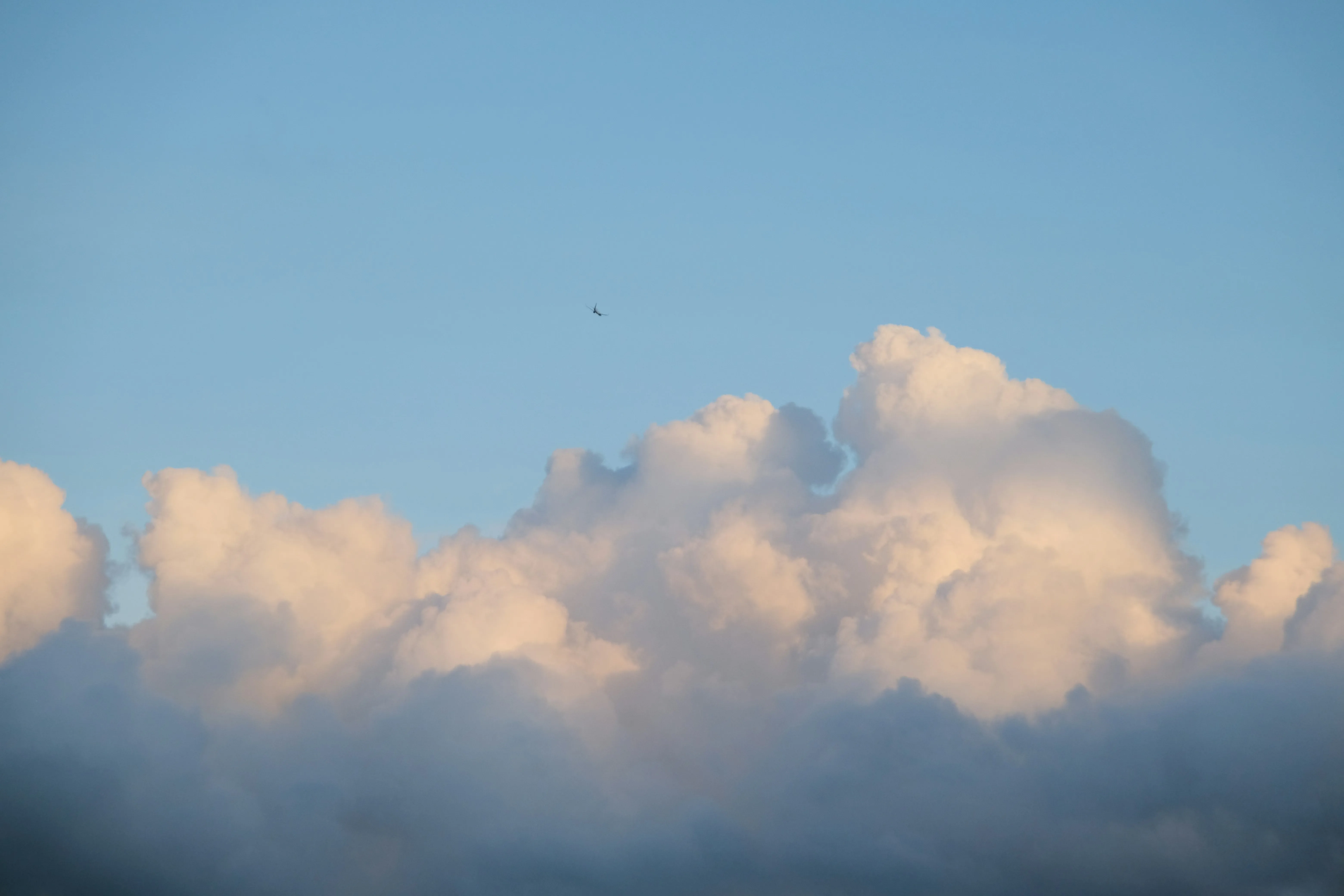 Fluffy White Clouds Floating in a Clear Blue Sky Wallpaper