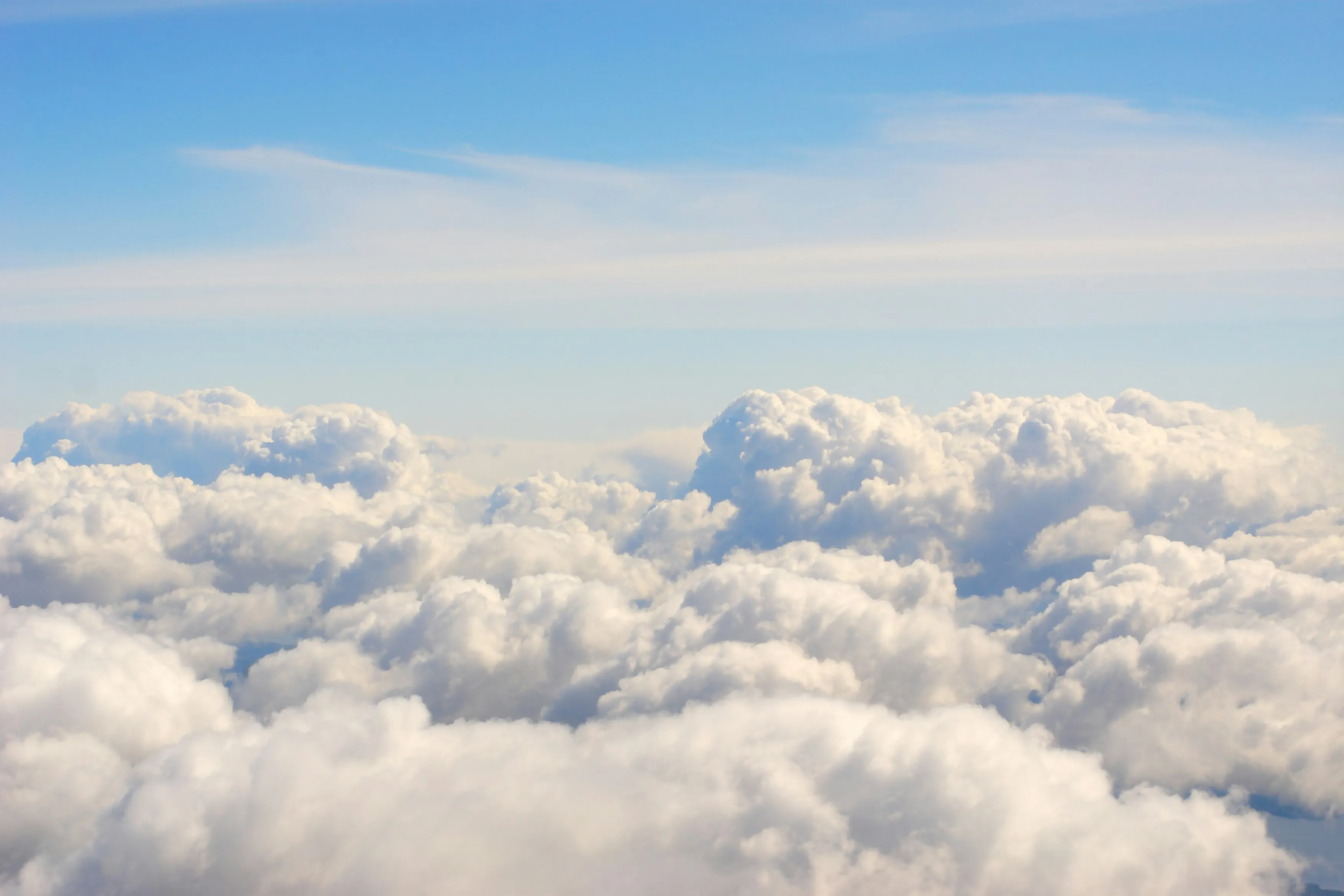 Fluffy White Clouds Forming a Soft Blanket Above Earth Image