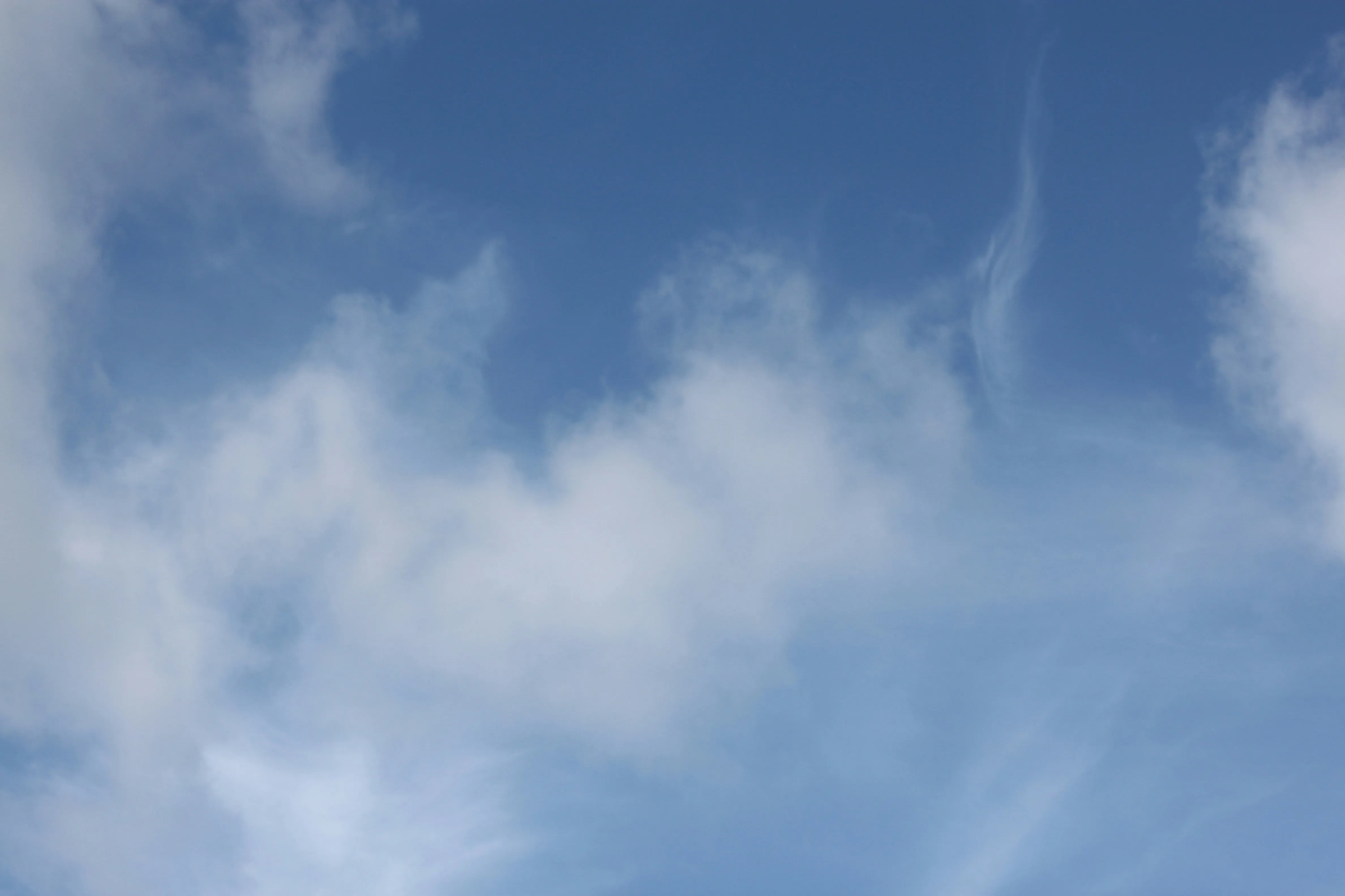 Fluffy White Clouds in a Soft Blue Sky Free HD Wallpaper