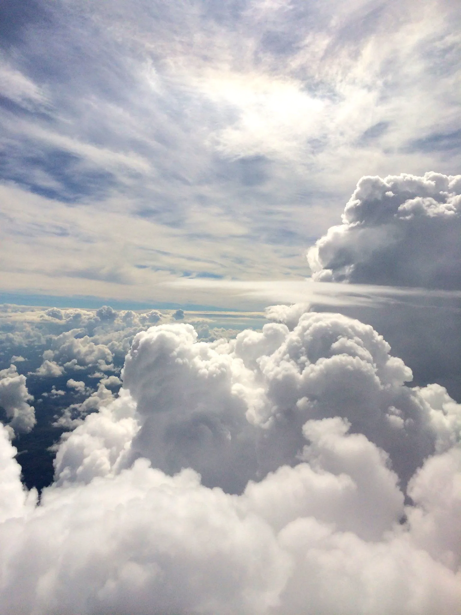 Fluffy White Clouds Seen From Above Over Mountains and Sky