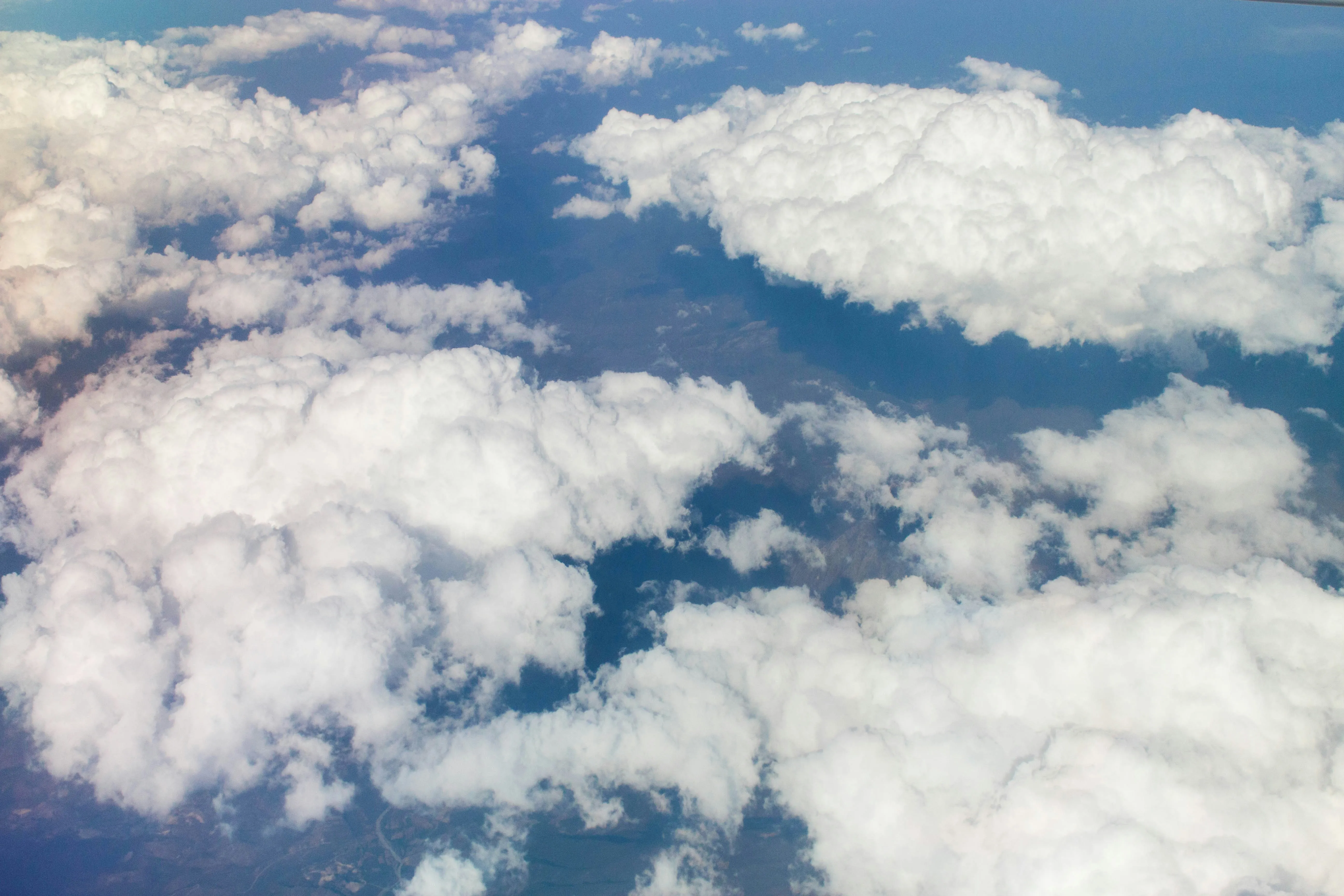 Fluffy White Clouds Viewed From Above Against Blue Sky