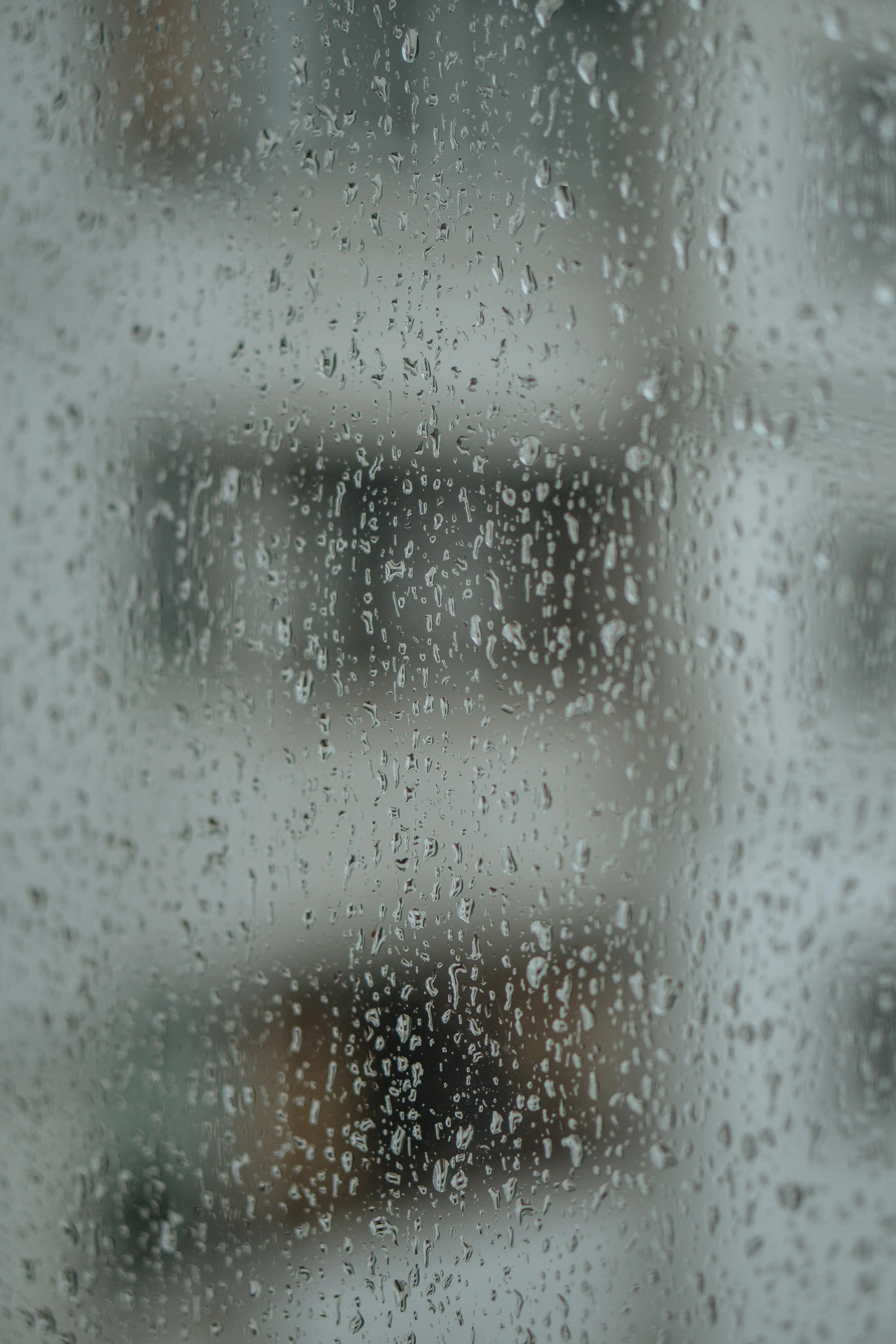 Foggy Window Surface Showing Rain and Blurred City