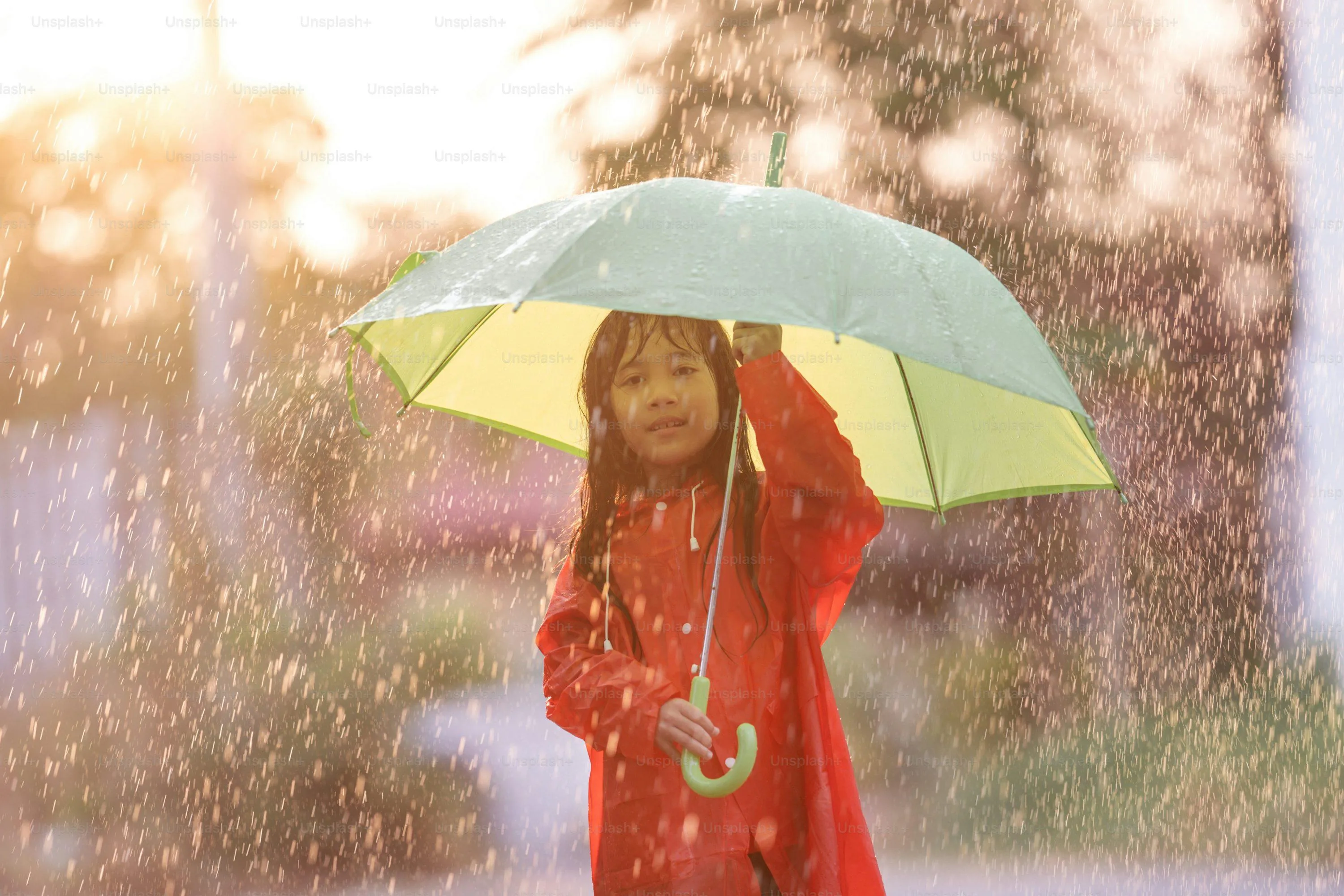 Girl Holding Yellow Umbrella Walking Through Park on Rainy Day