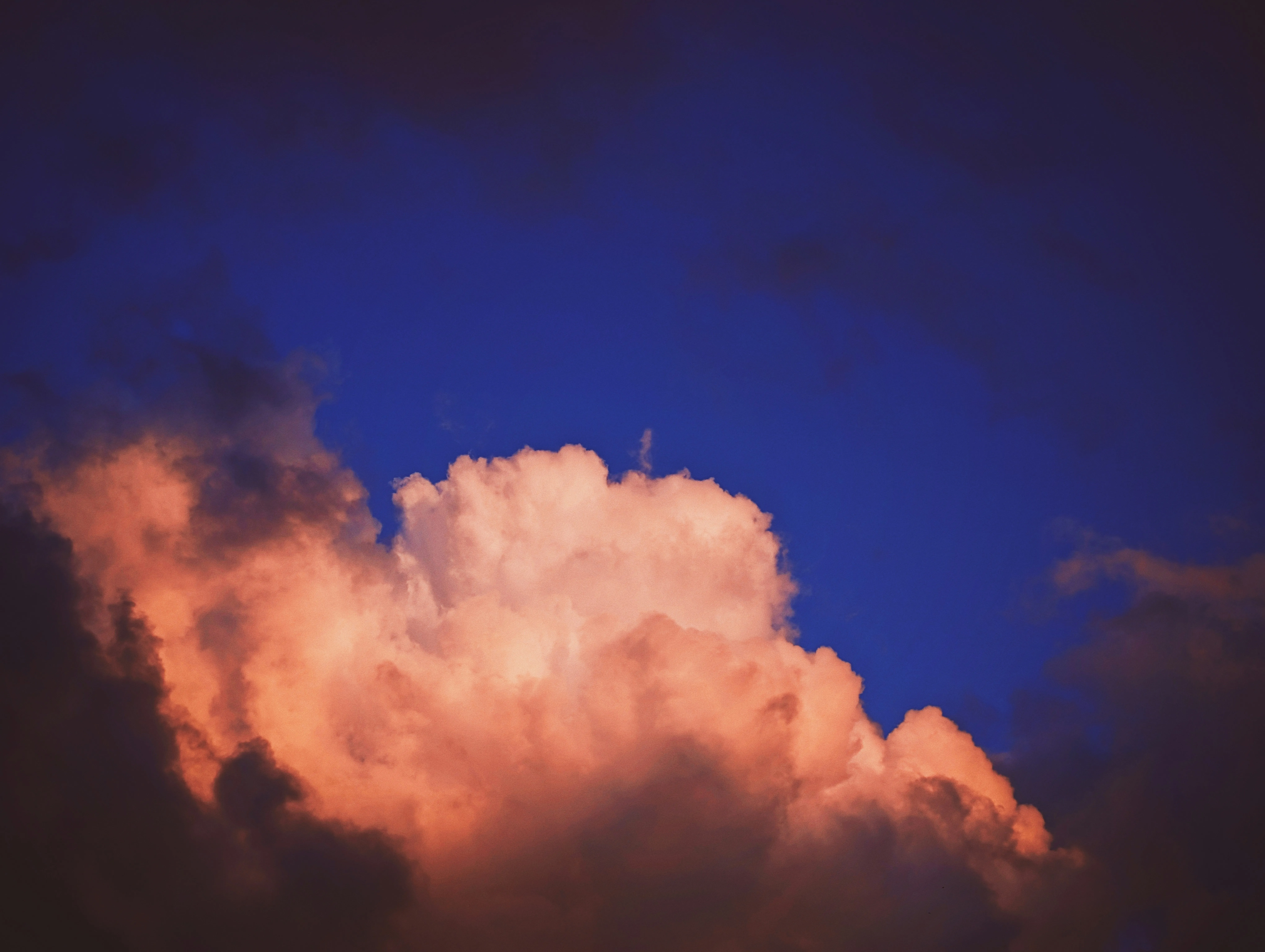 Glowing Cloud Against a Rich Blue and Purple Sky Wallpaper