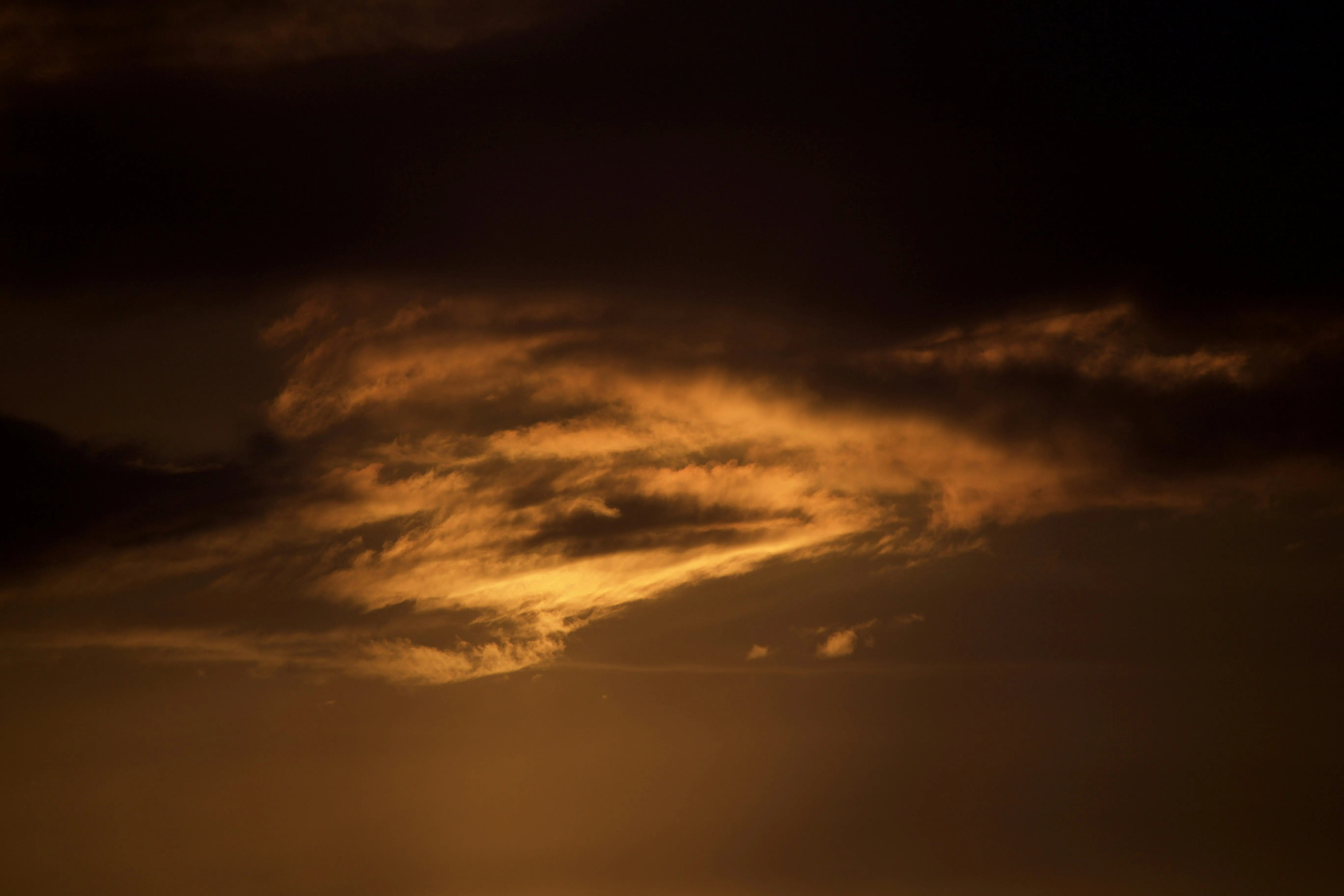 Glowing Storm Clouds Forming Under Dark Golden Sky HD