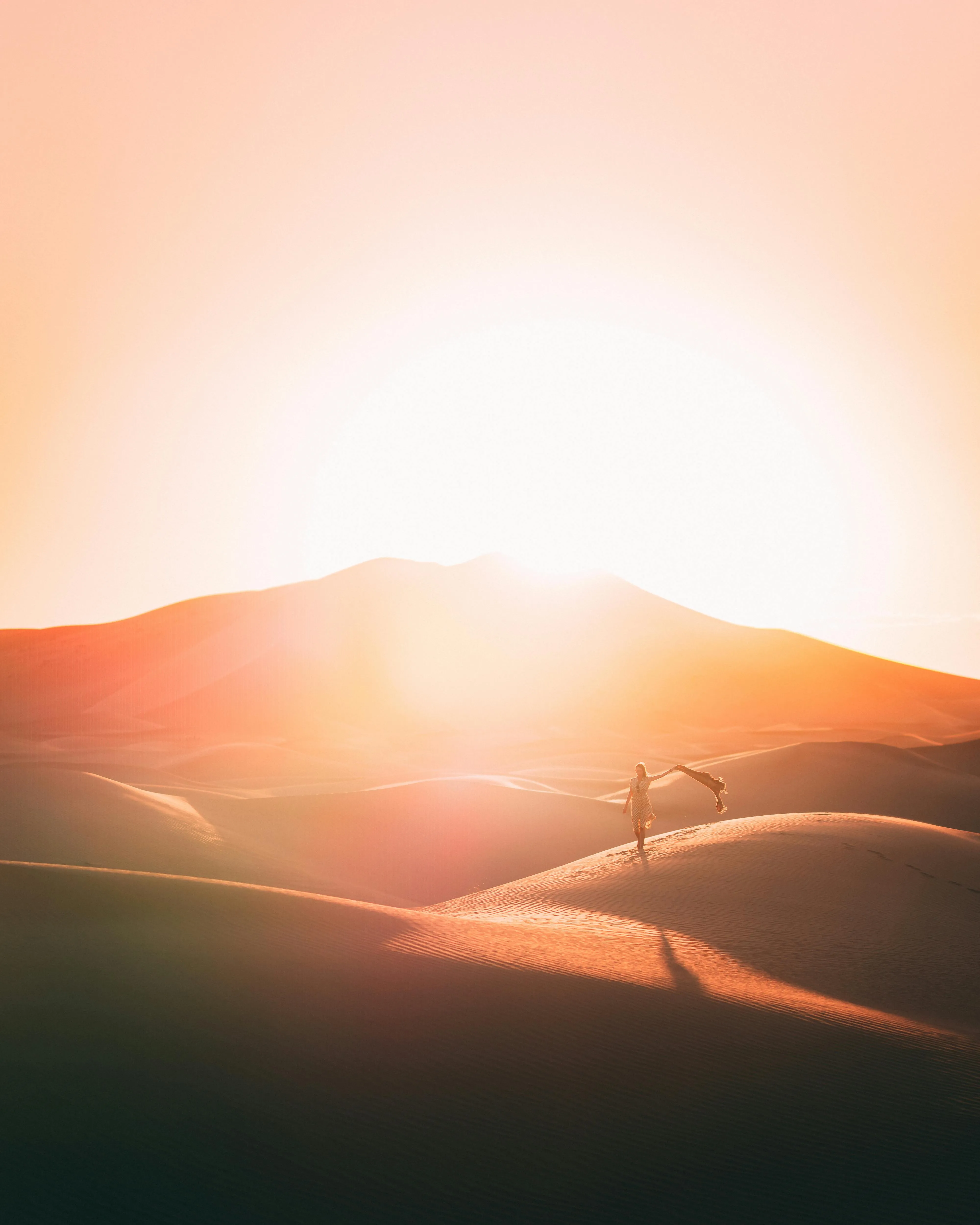 Glowing Sun Behind Hills Under Pale Foggy Sky Wallpaper