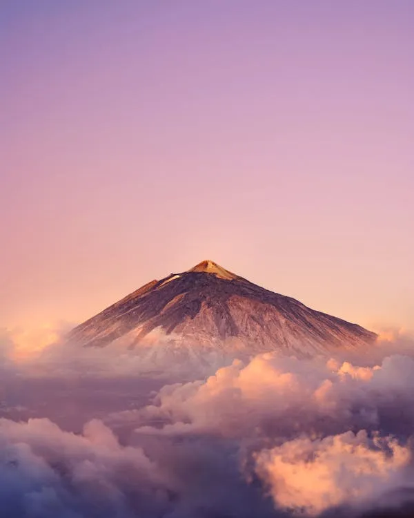 Glowing Volcano Surrounded By Vibrant Red Evening Skies