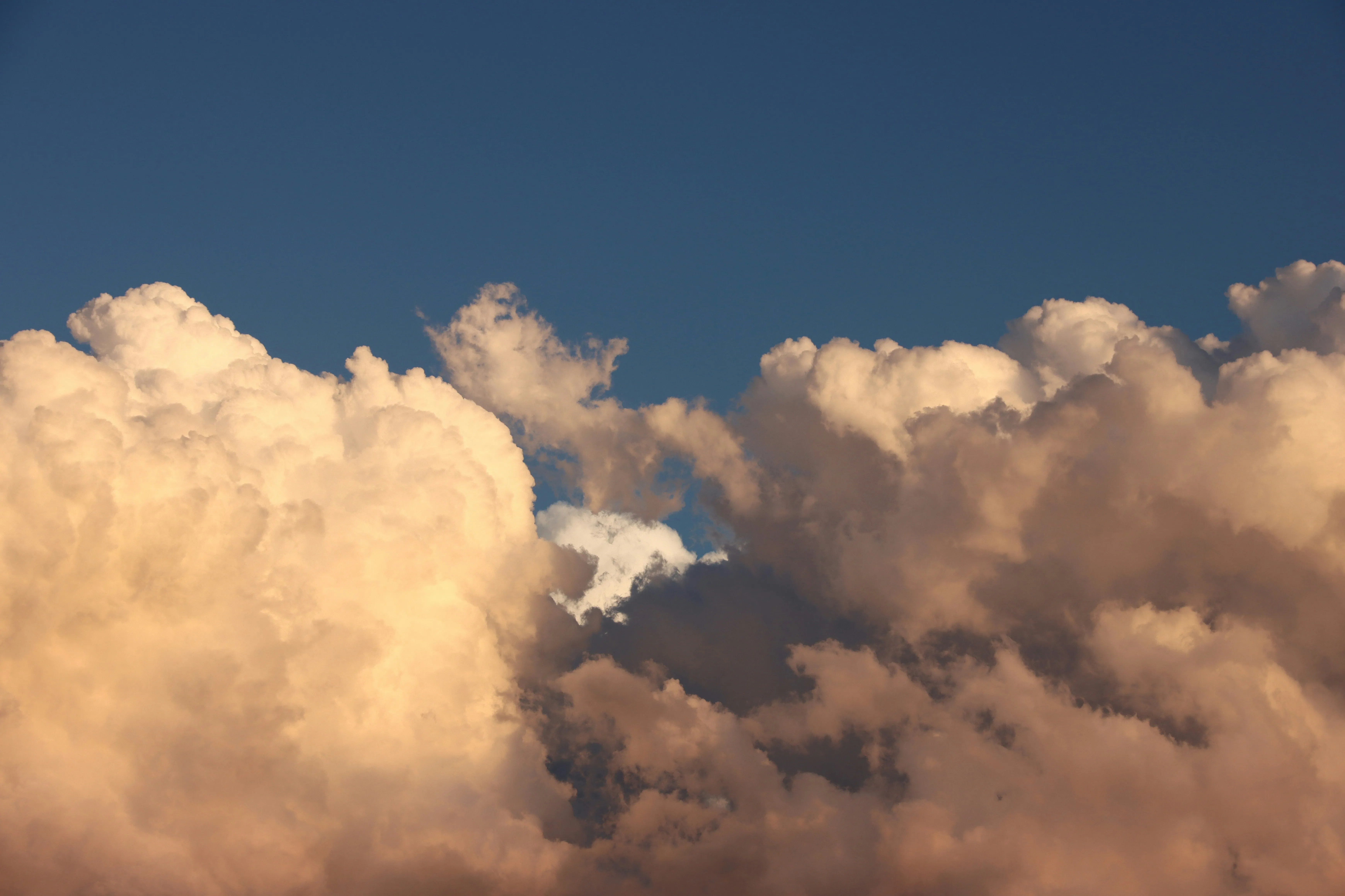 Golden Hour Clouds Glowing in Warm Sunset Light Wallpaper