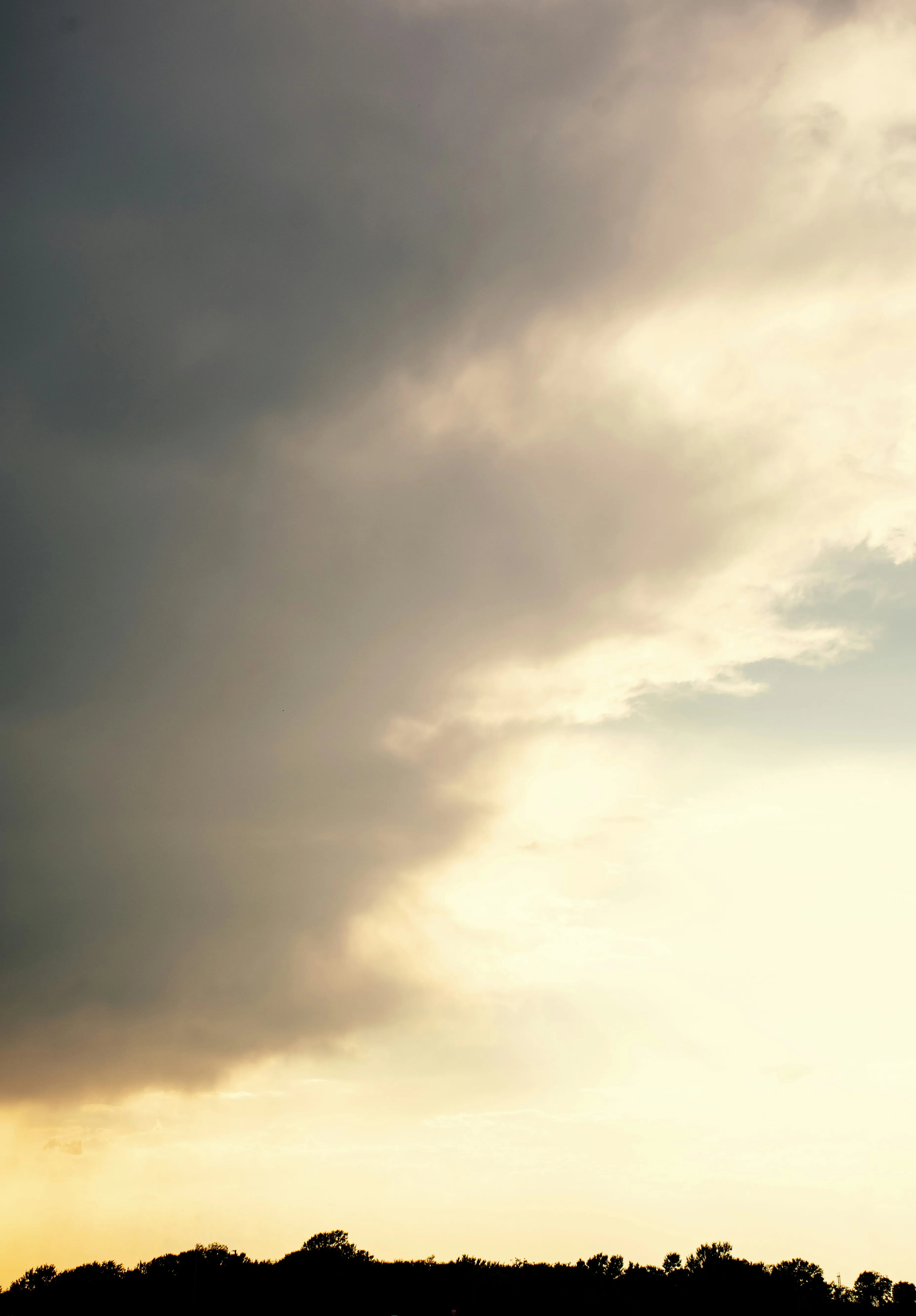 Golden Sun Breaking Through Towering Storm Clouds Image