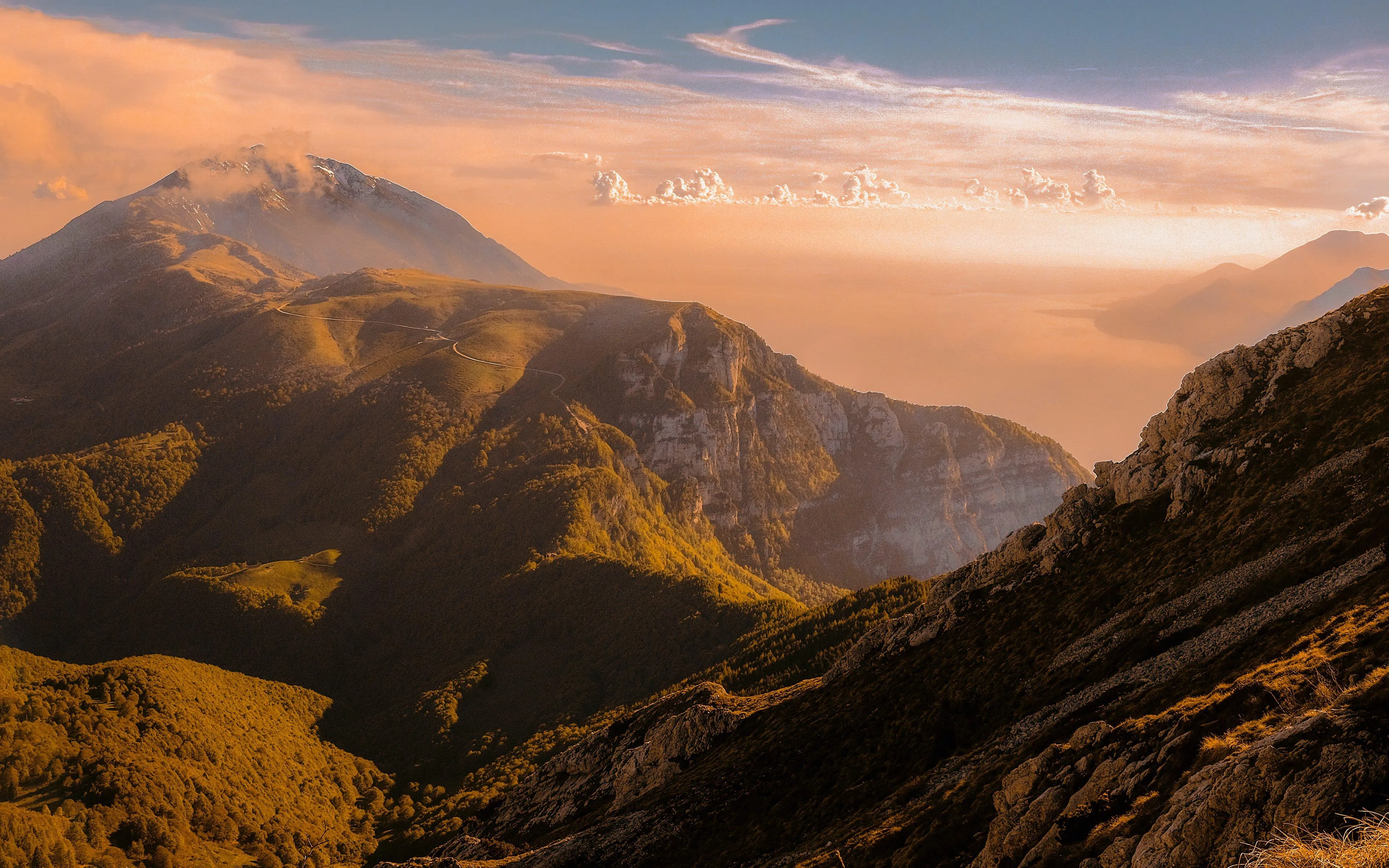 Golden sunset casting warm light over mountain landscape