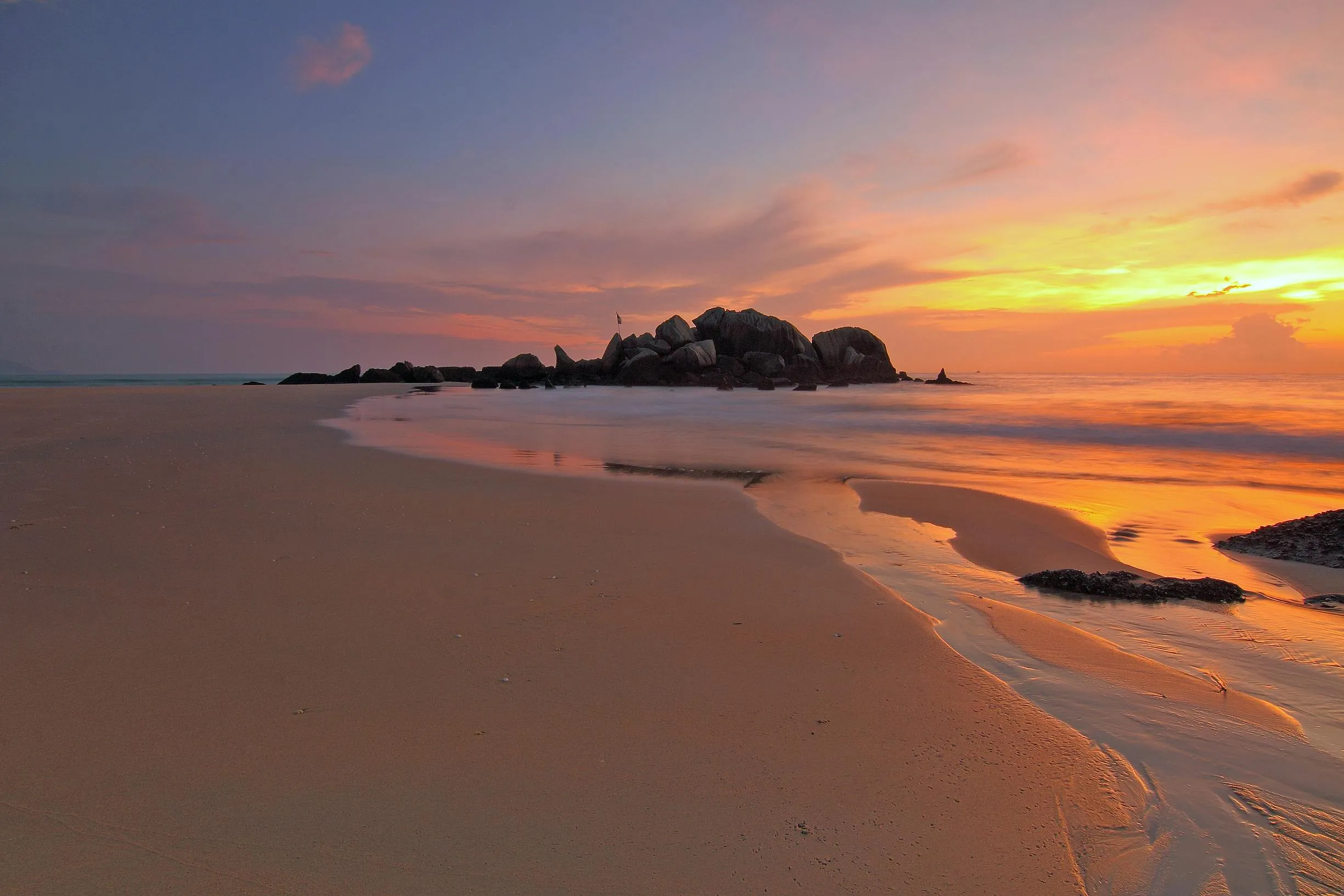 Golden Sunset Glowing Over a Peaceful Beach and Clouds