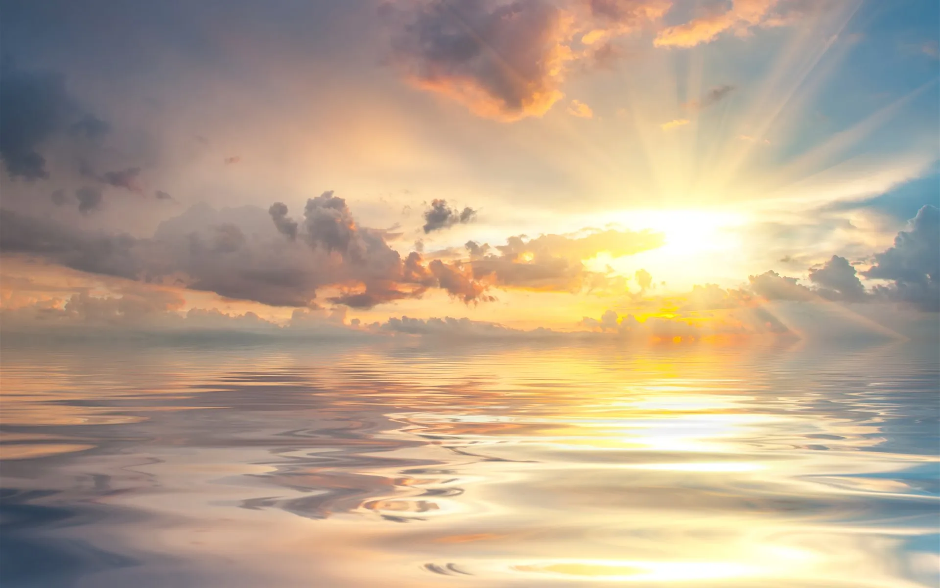 Golden Sunset Light Reflecting on Calm Water and Cloudy Sky