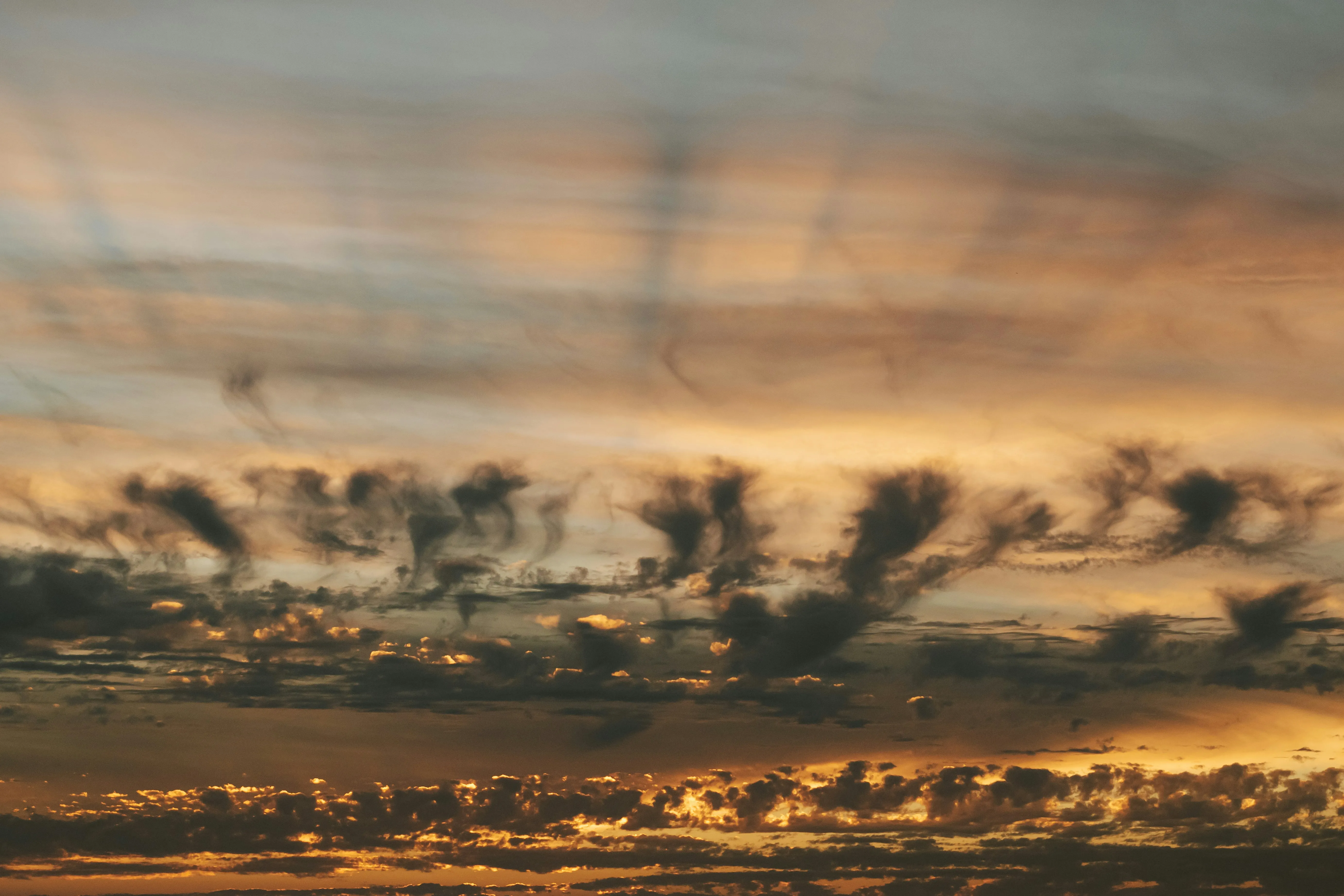 Golden Sunset with Rays of Light Through Dark Clouds