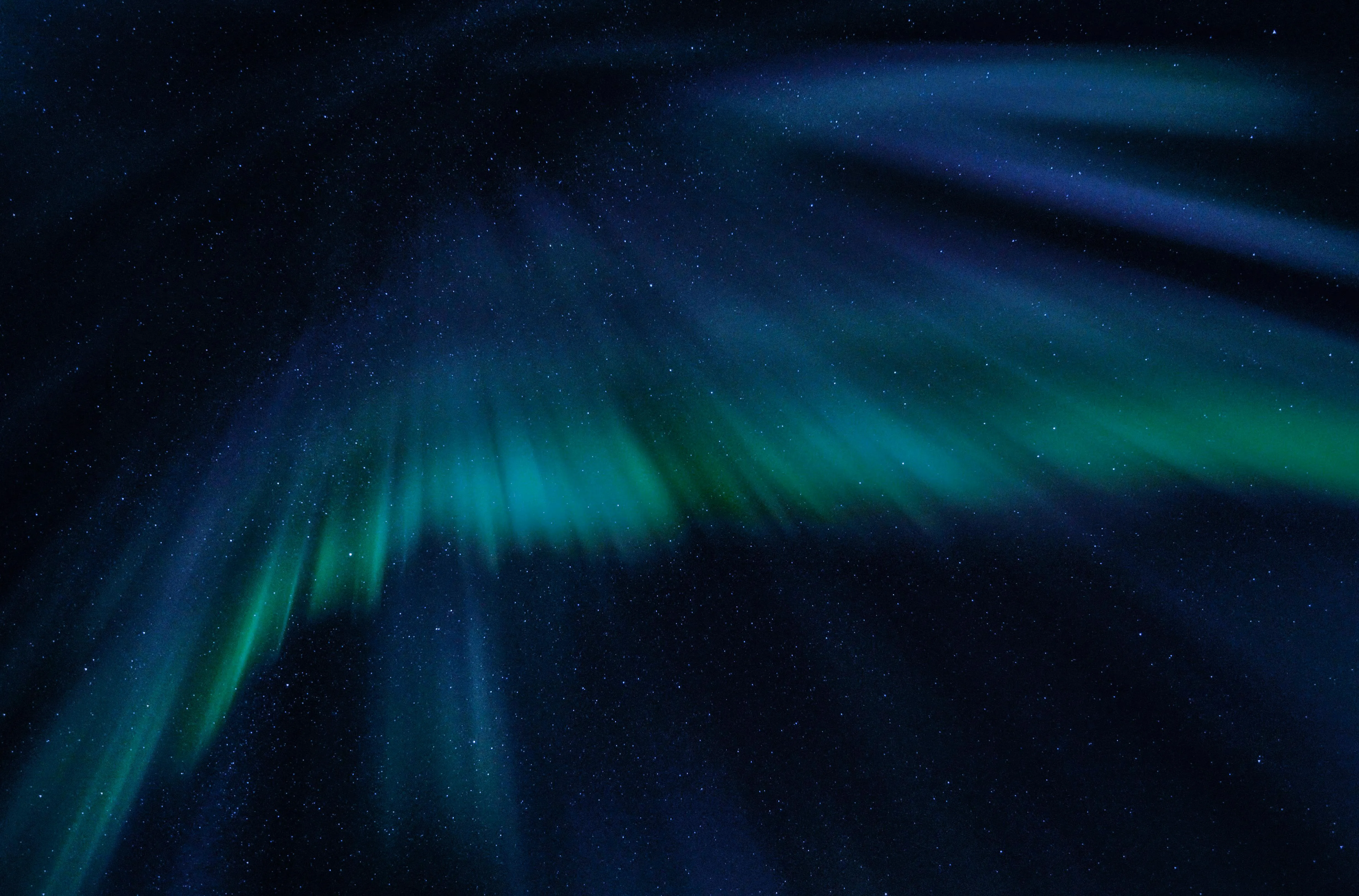 Green and Blue Northern Lights Glowing in Night Sky