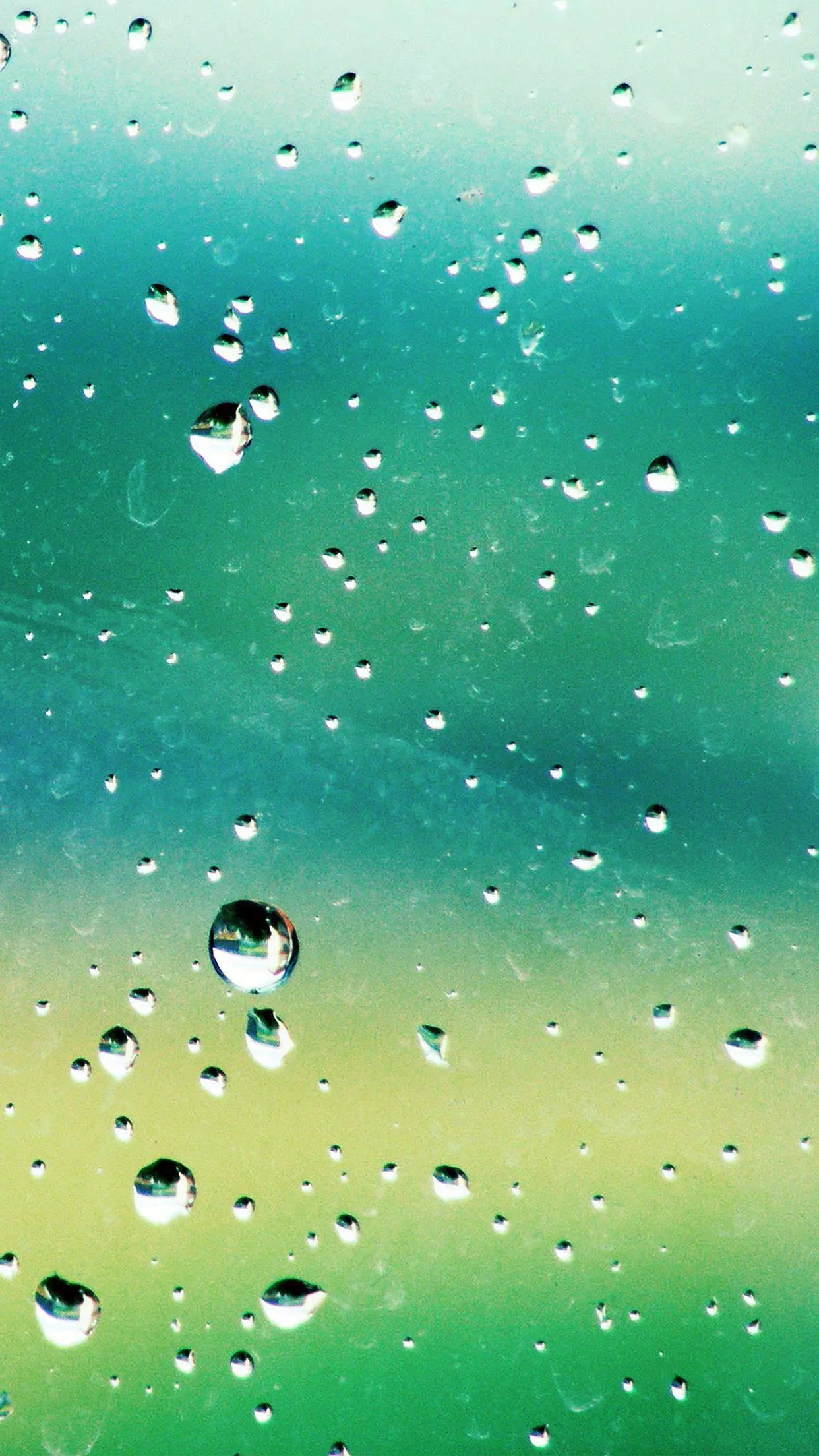 Green Blurred Background with Falling Rain and Droplets