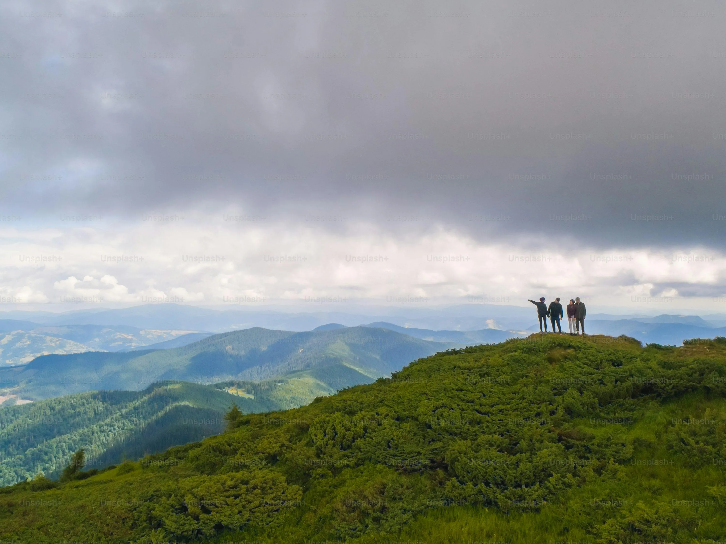 Green Hillside with Mist and Rain Clouds on Distant Mountain