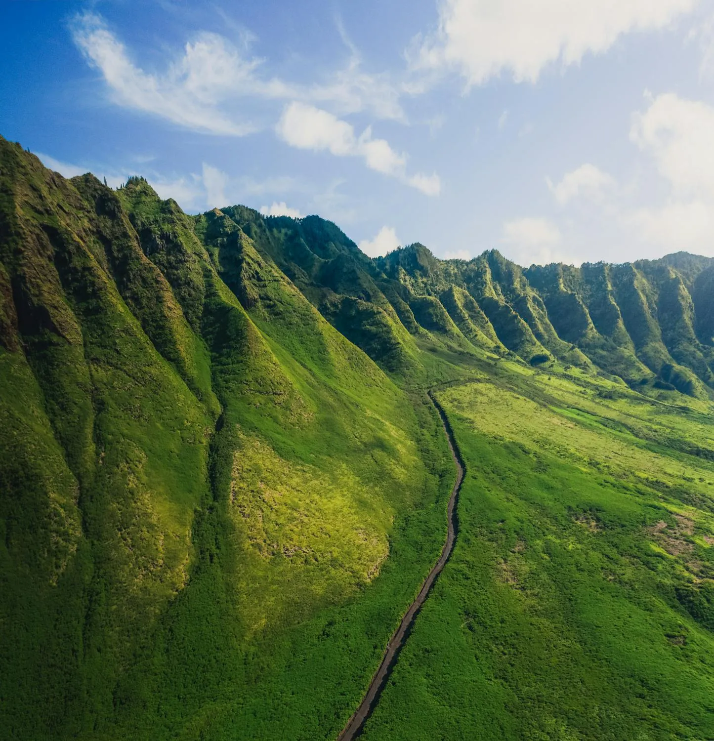 Green Mountain Landscape Under Bright Blue Cloudy Sky
