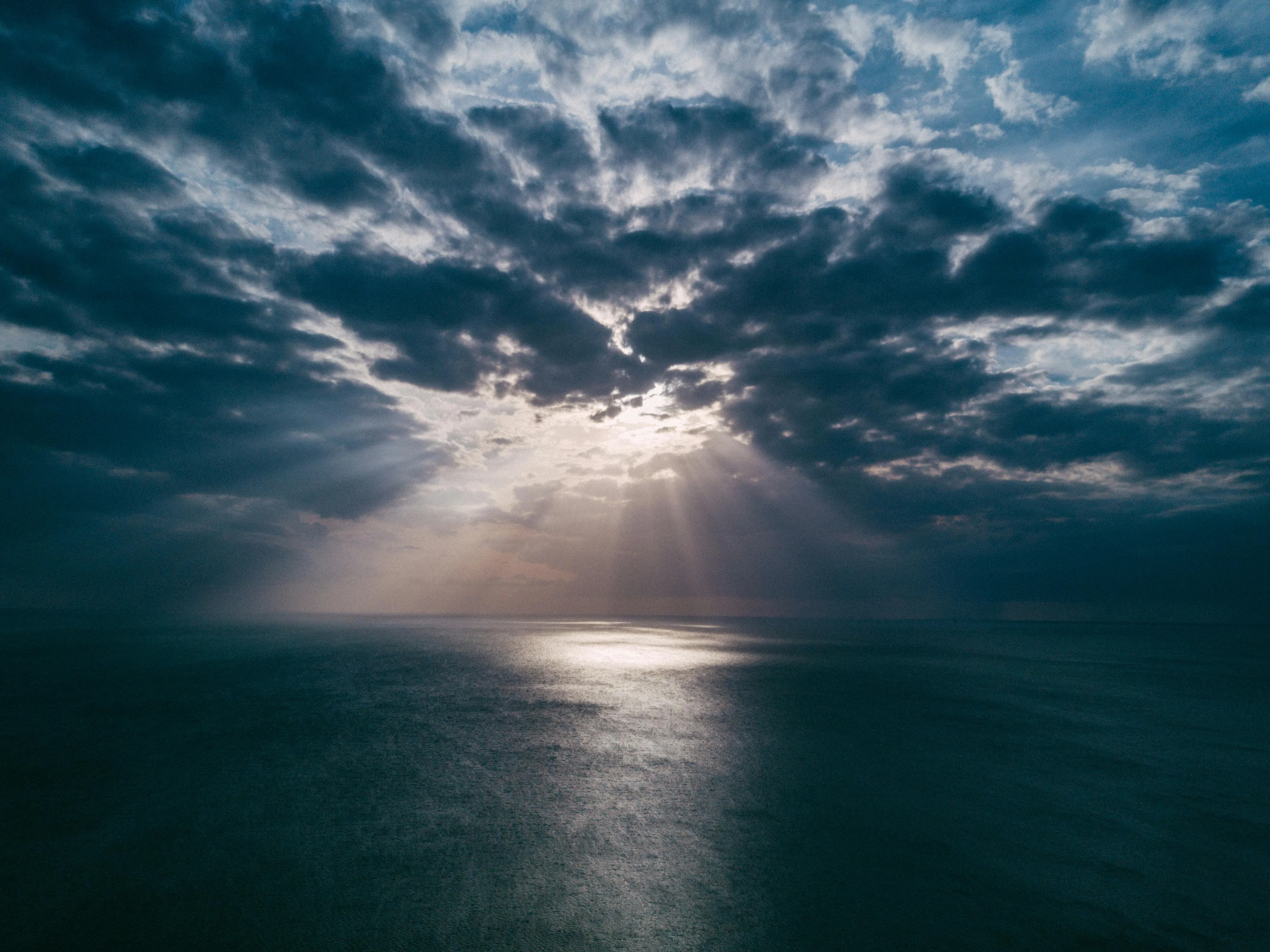 Heavenly Rays of Sunlight Breaking Through Ocean Clouds