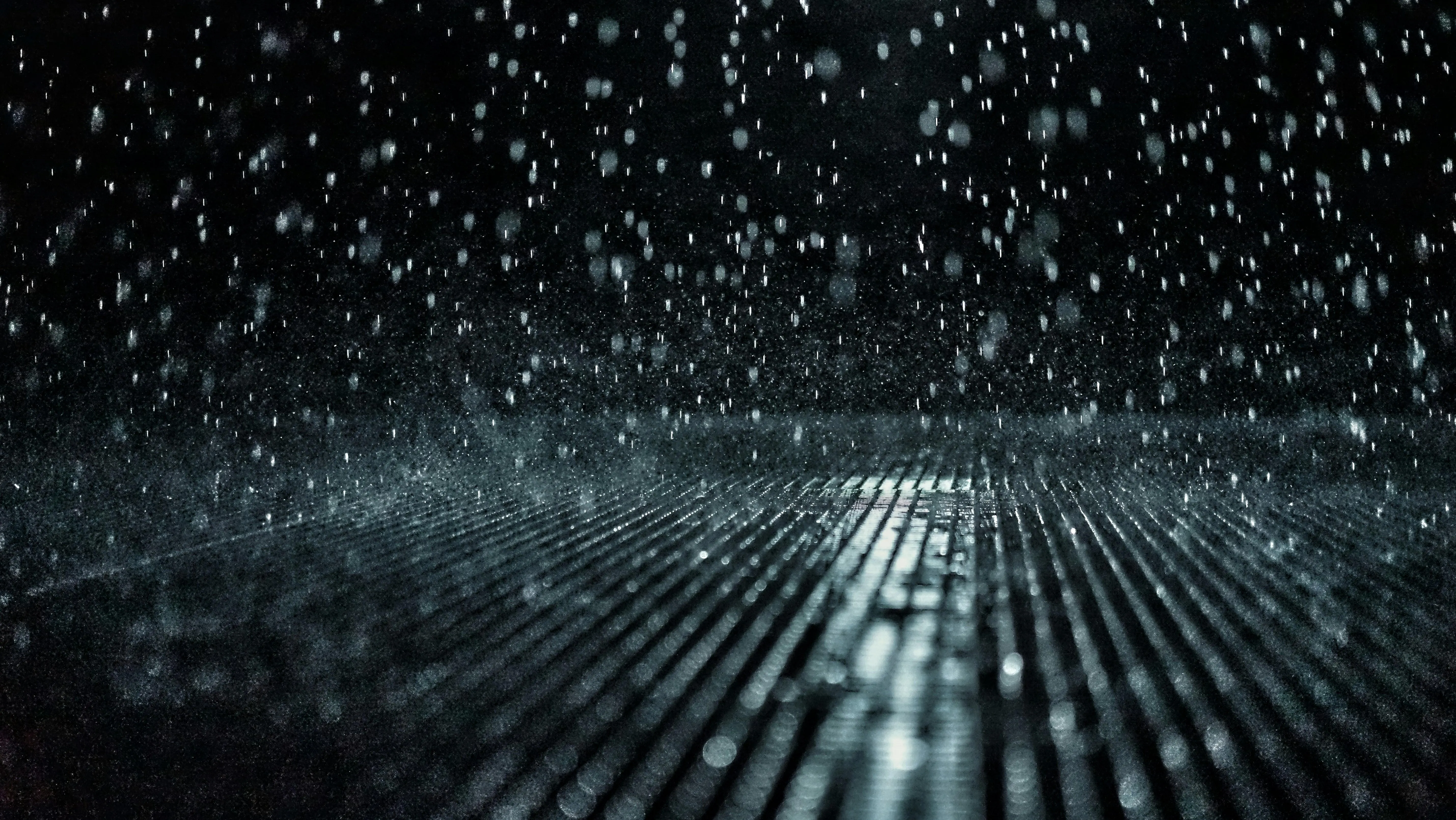 Heavy Rainfall at Night with Splashing Pavement Image