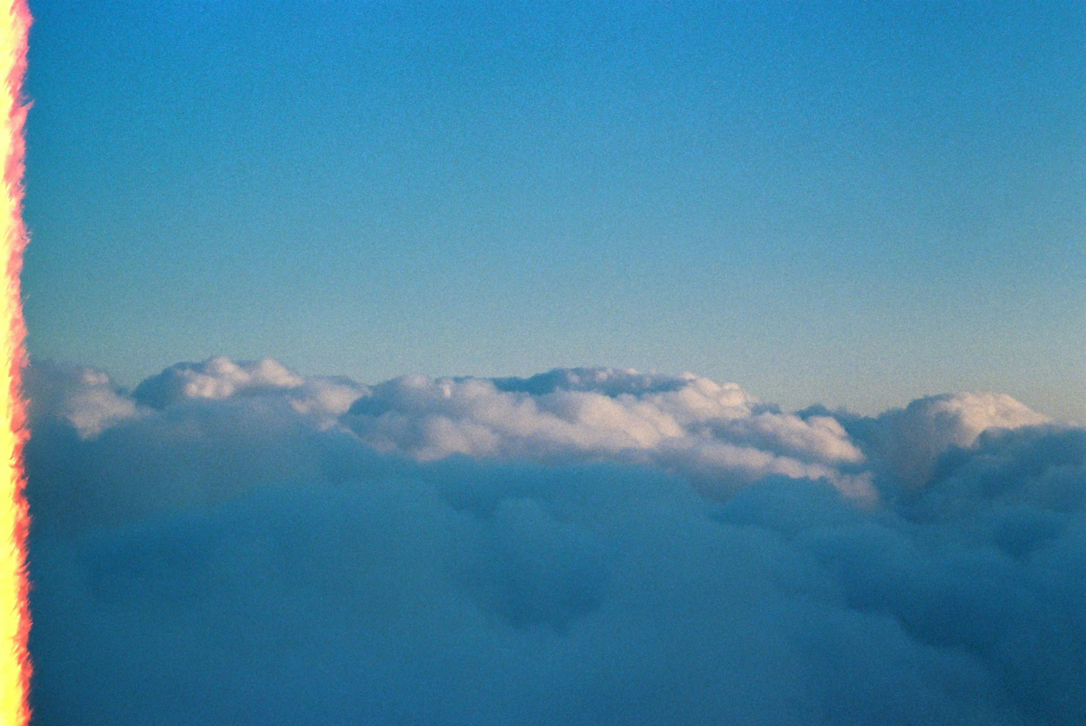 High Altitude View of Clouds Above the Atmosphere Wallpaper
