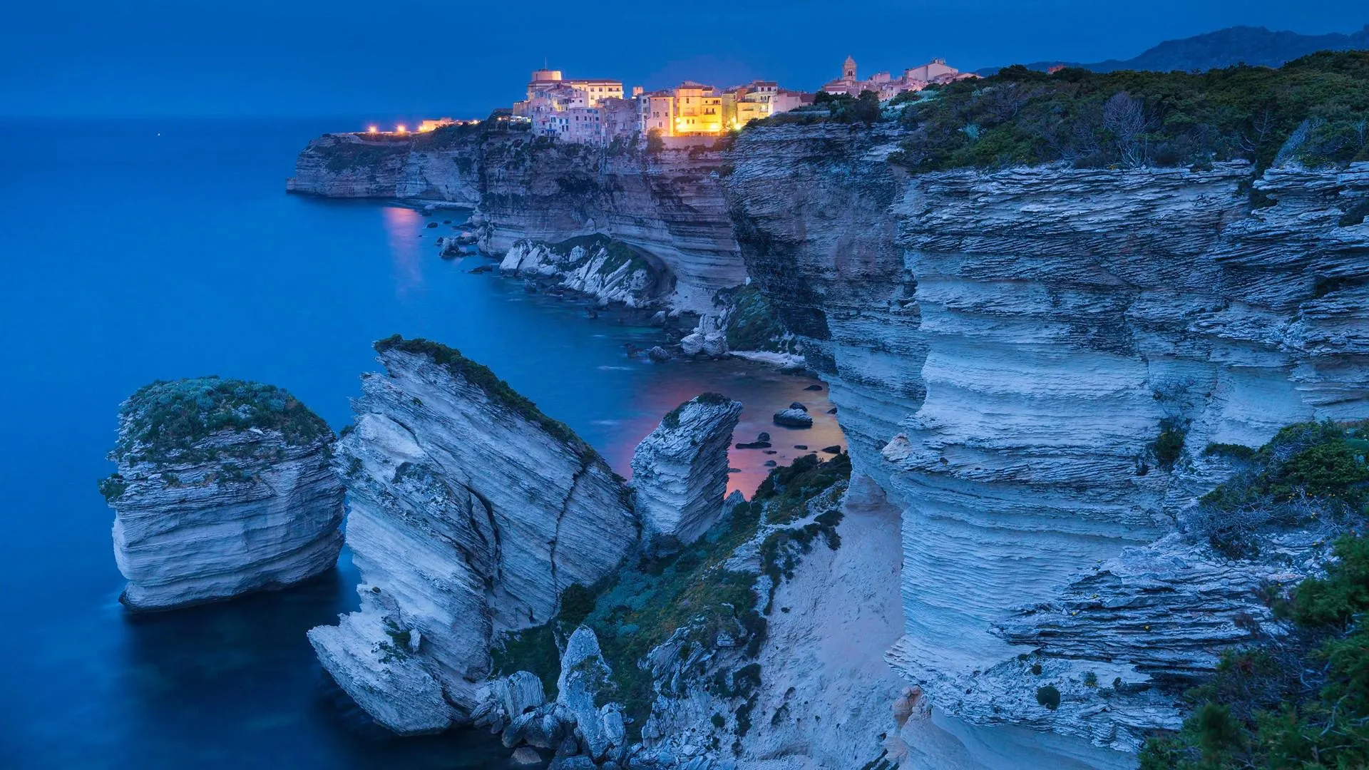 Historic hill town with blue buildings and lights image