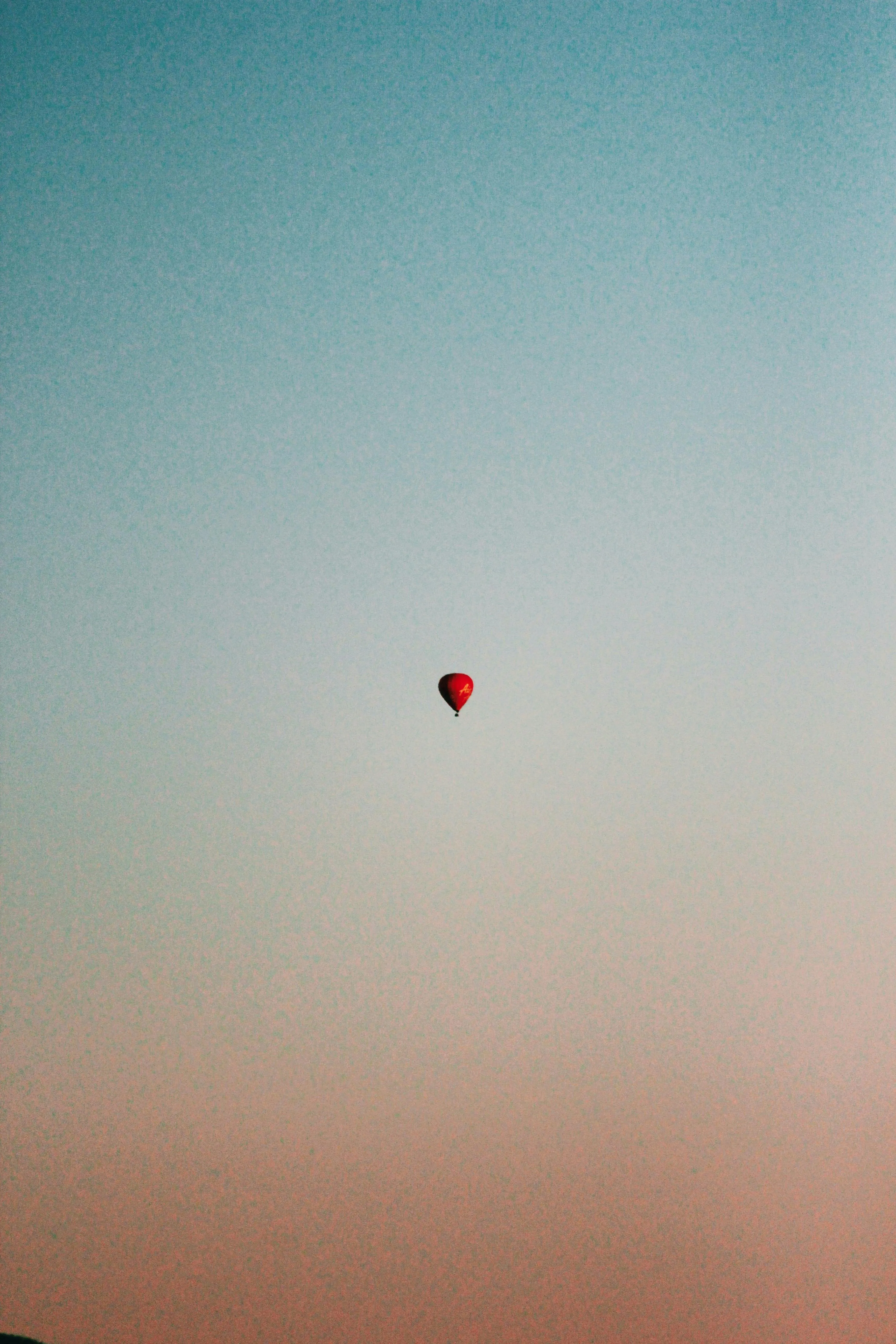 Hot Air Balloon Floating Against a Gradient Sunset Sky