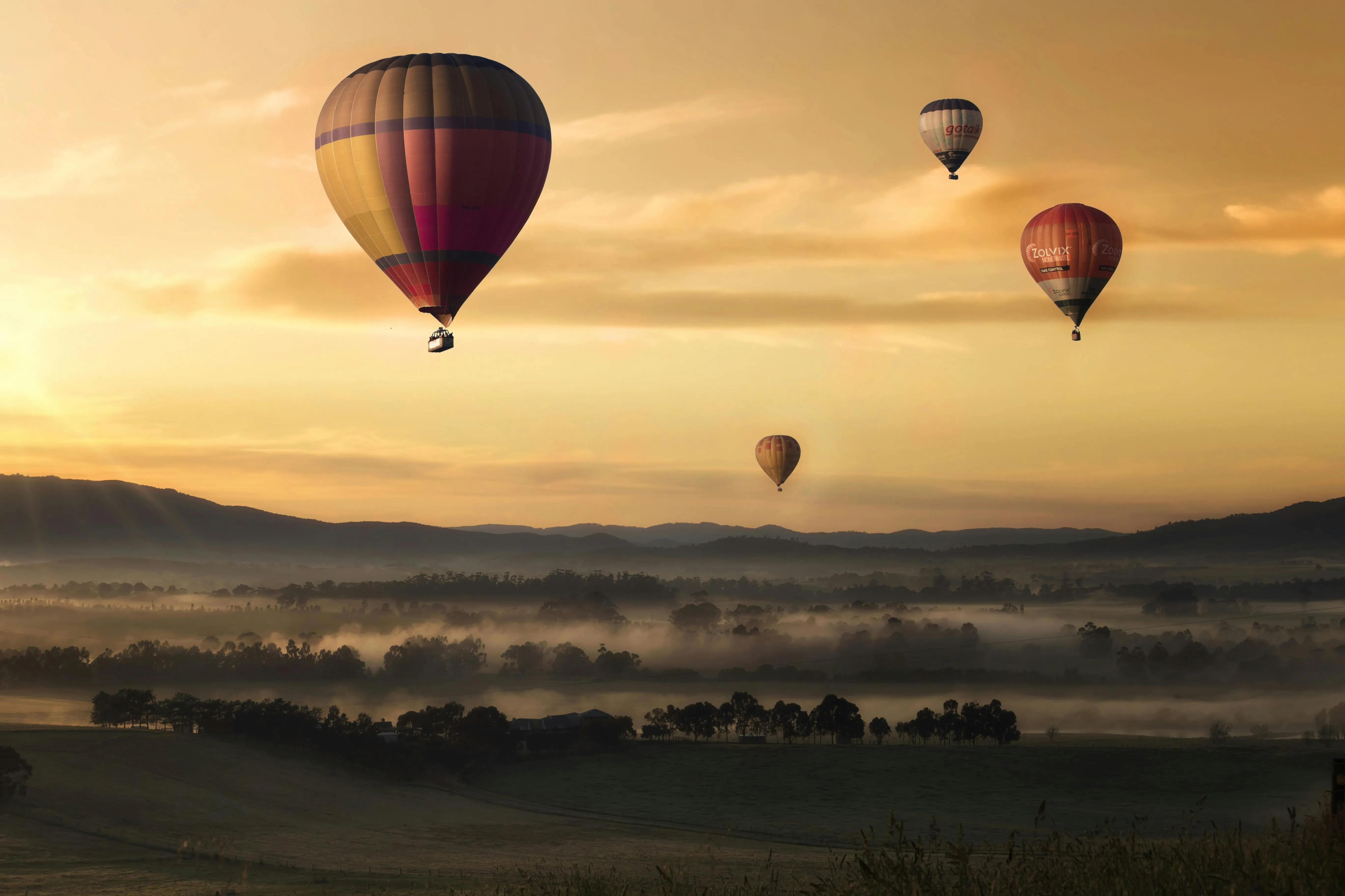 Hot Air Balloons Rising Against a Morning Sky Wallpaper