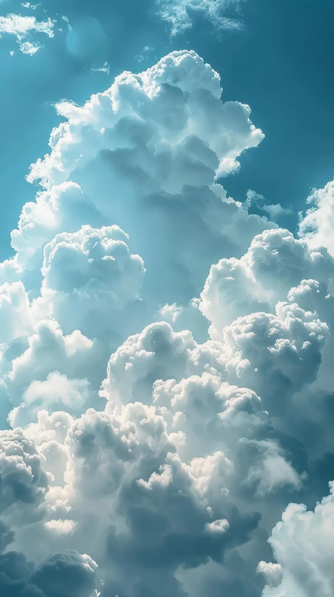 Image of Towering White Cumulus Clouds Against Blue Sky