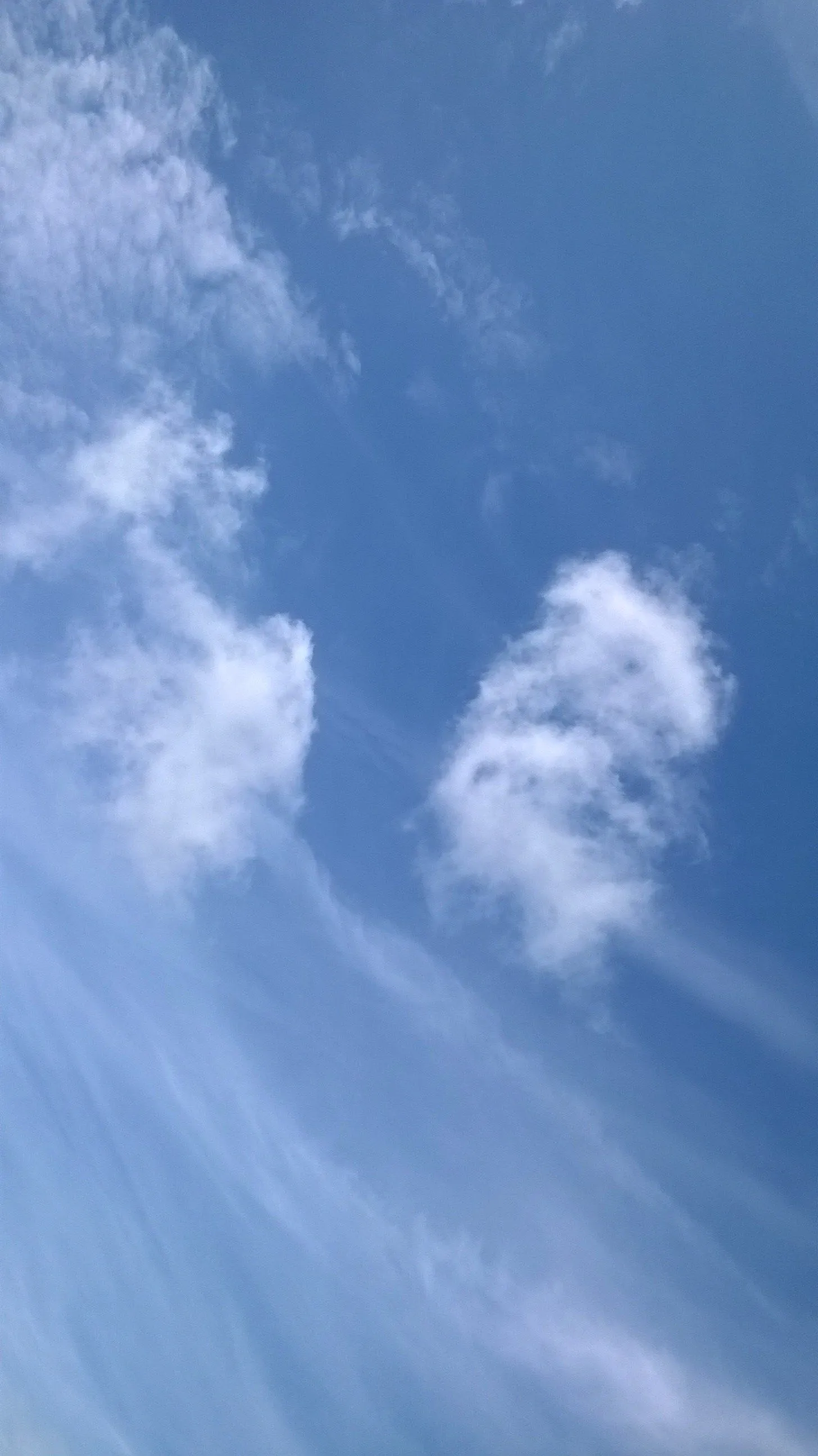 Image of Wispy White Clouds Stretch Across a Bright Blue Sky