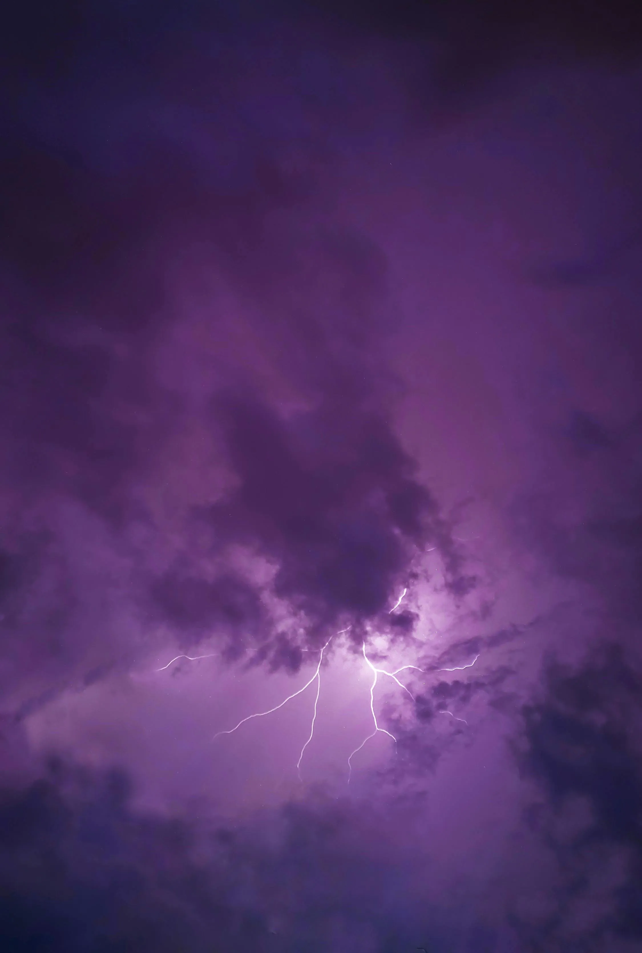 Intense Purple Thunderstorm Clouds with Lightning Wallpaper