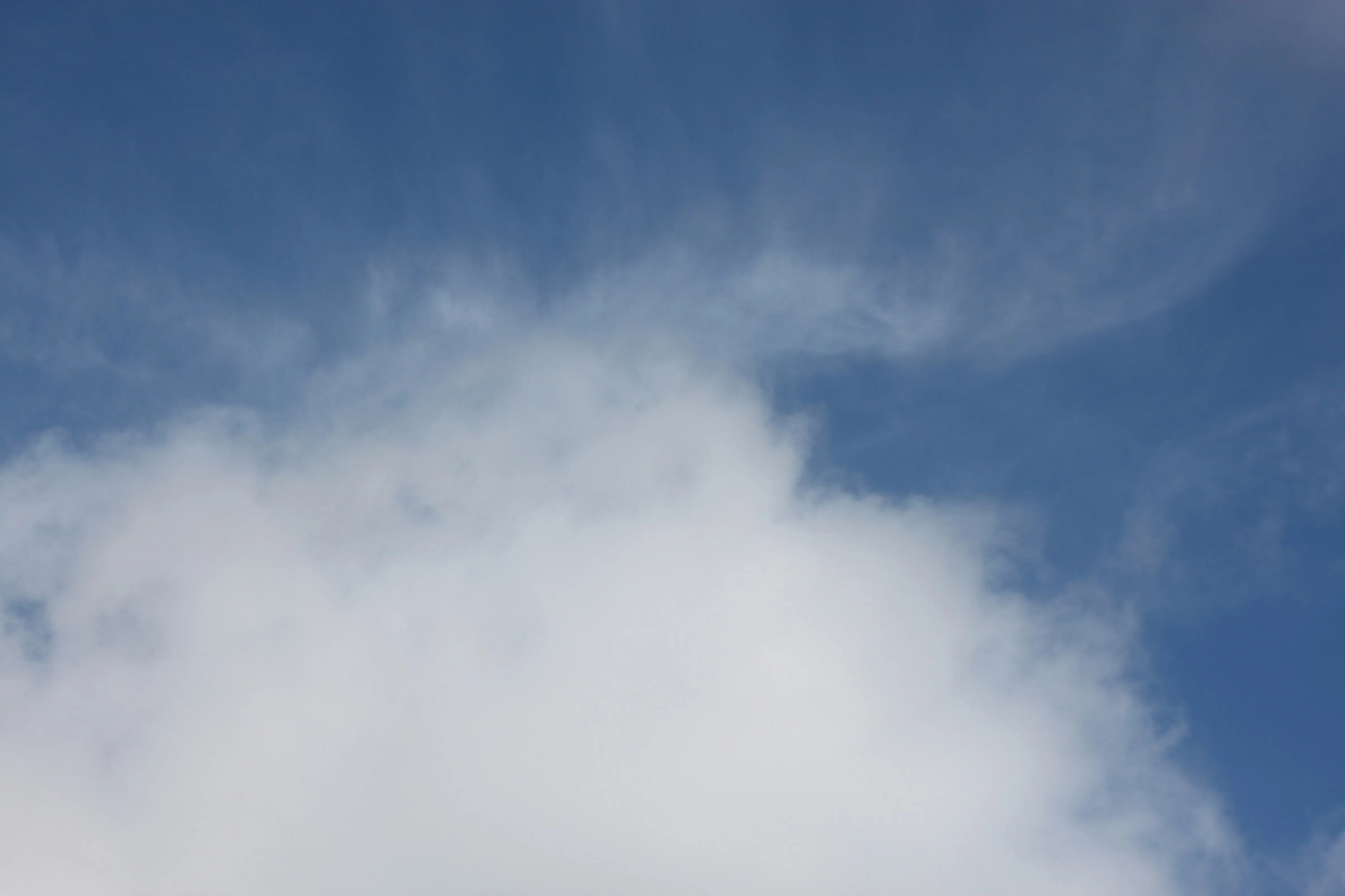 Isolated Patch of White Clouds in a Clear Blue Sky