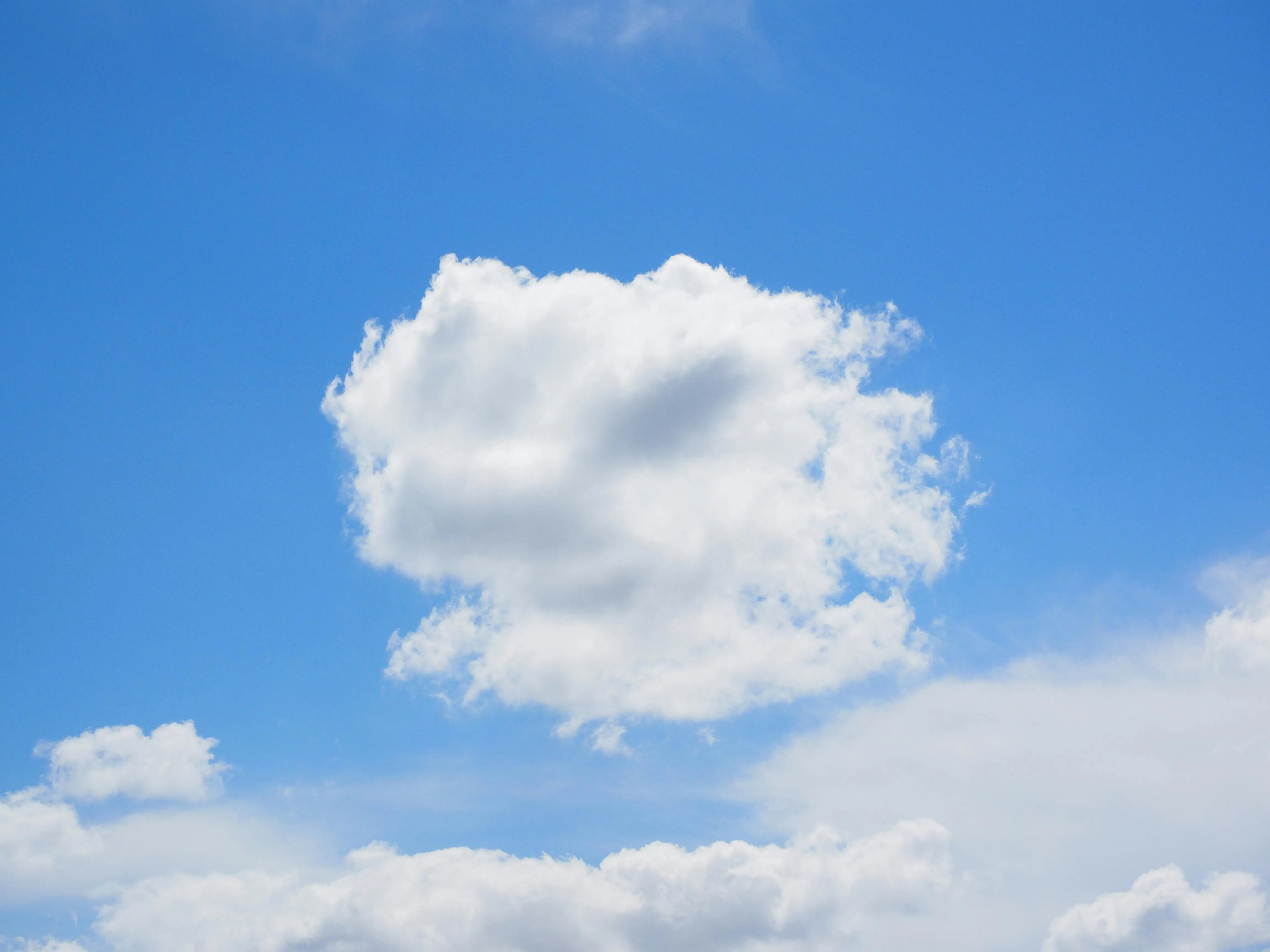 Isolated White Cloud Floating in Midday Blue Sky Image