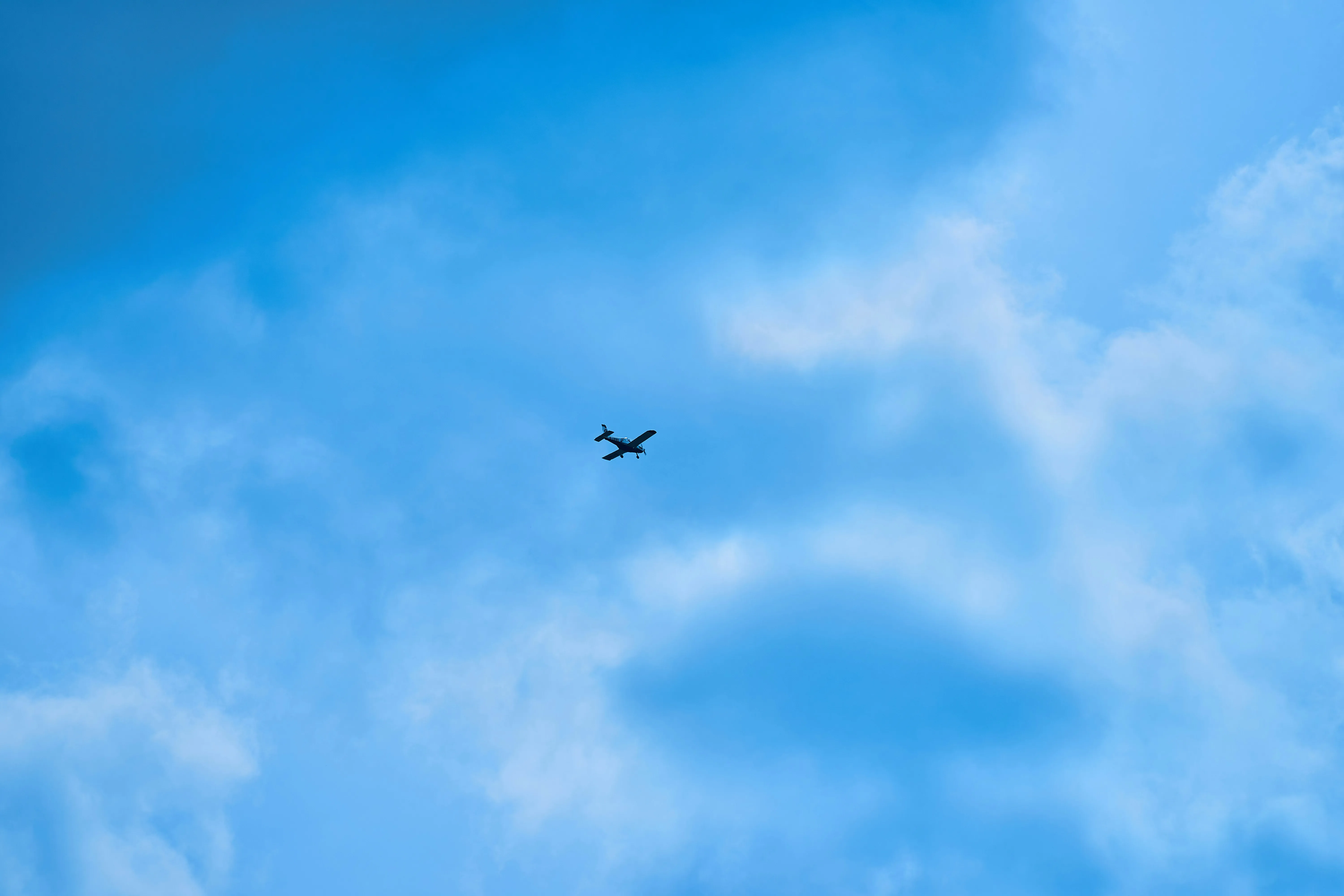 Jetplane Flying Freely Against Clear Blue Sky Wallpaper