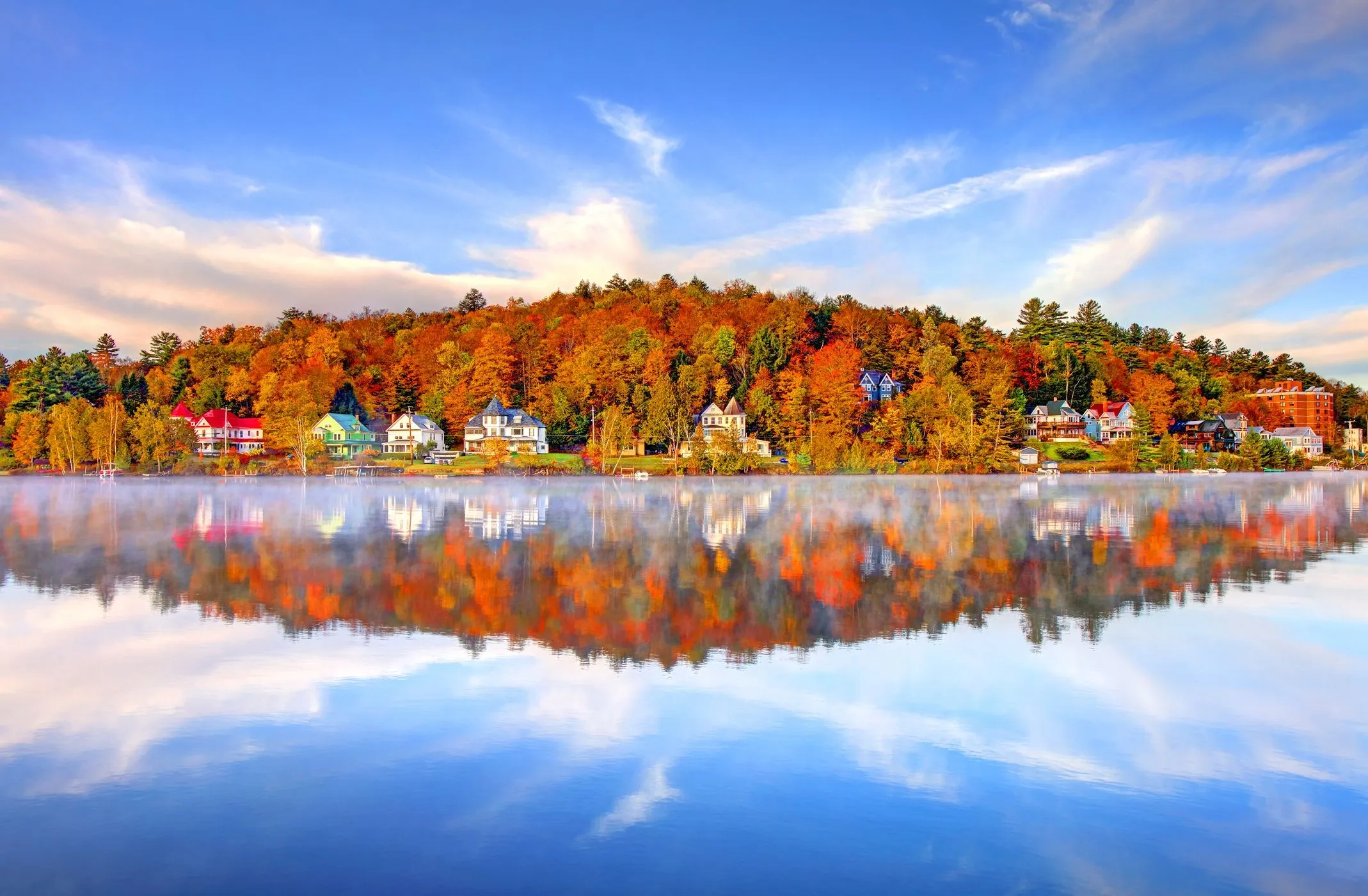 Lake Reflecting Colorful Autumn Trees and Bright Blue Sky