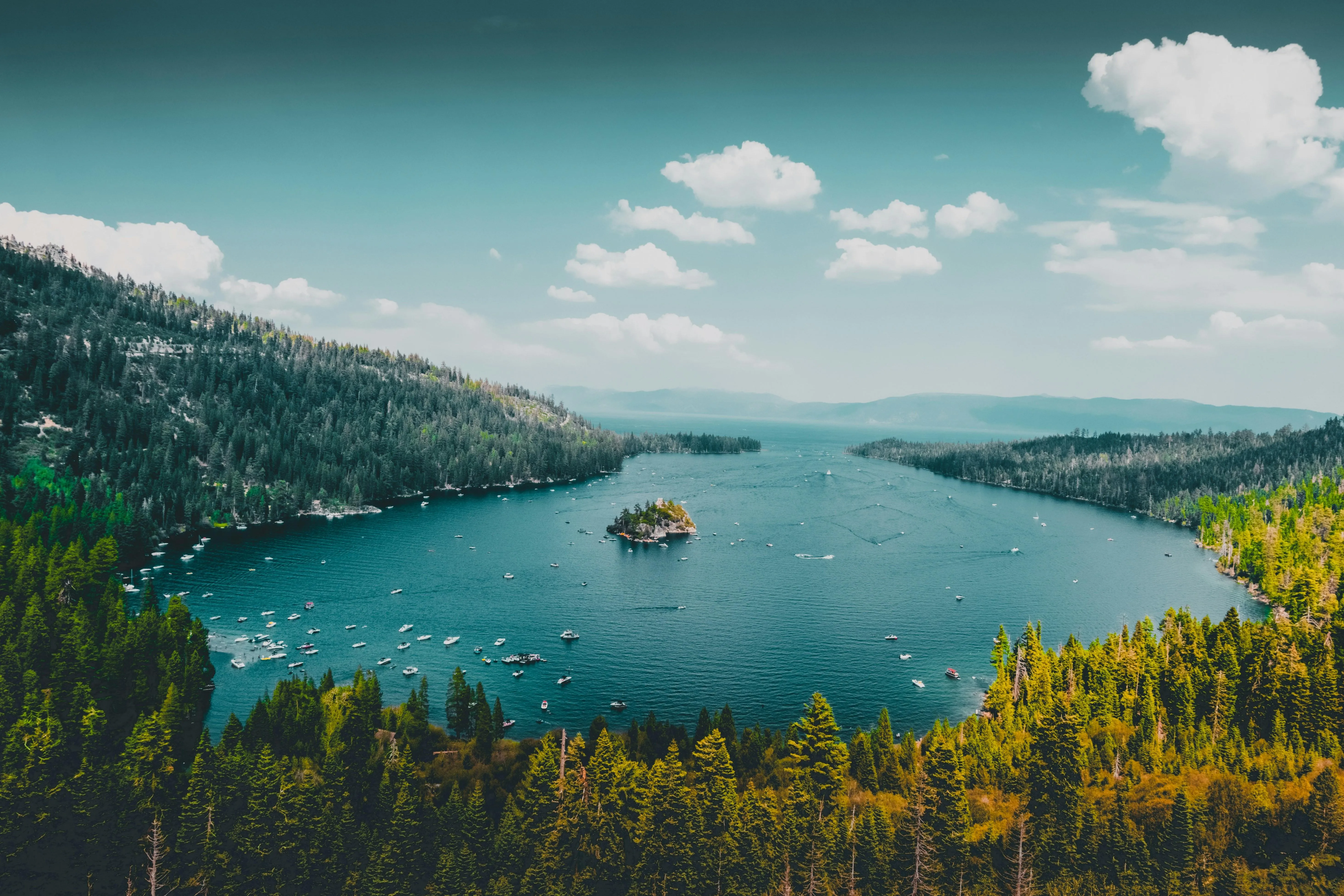 Lake Surrounded by Hills and Trees Under Blue Sky image