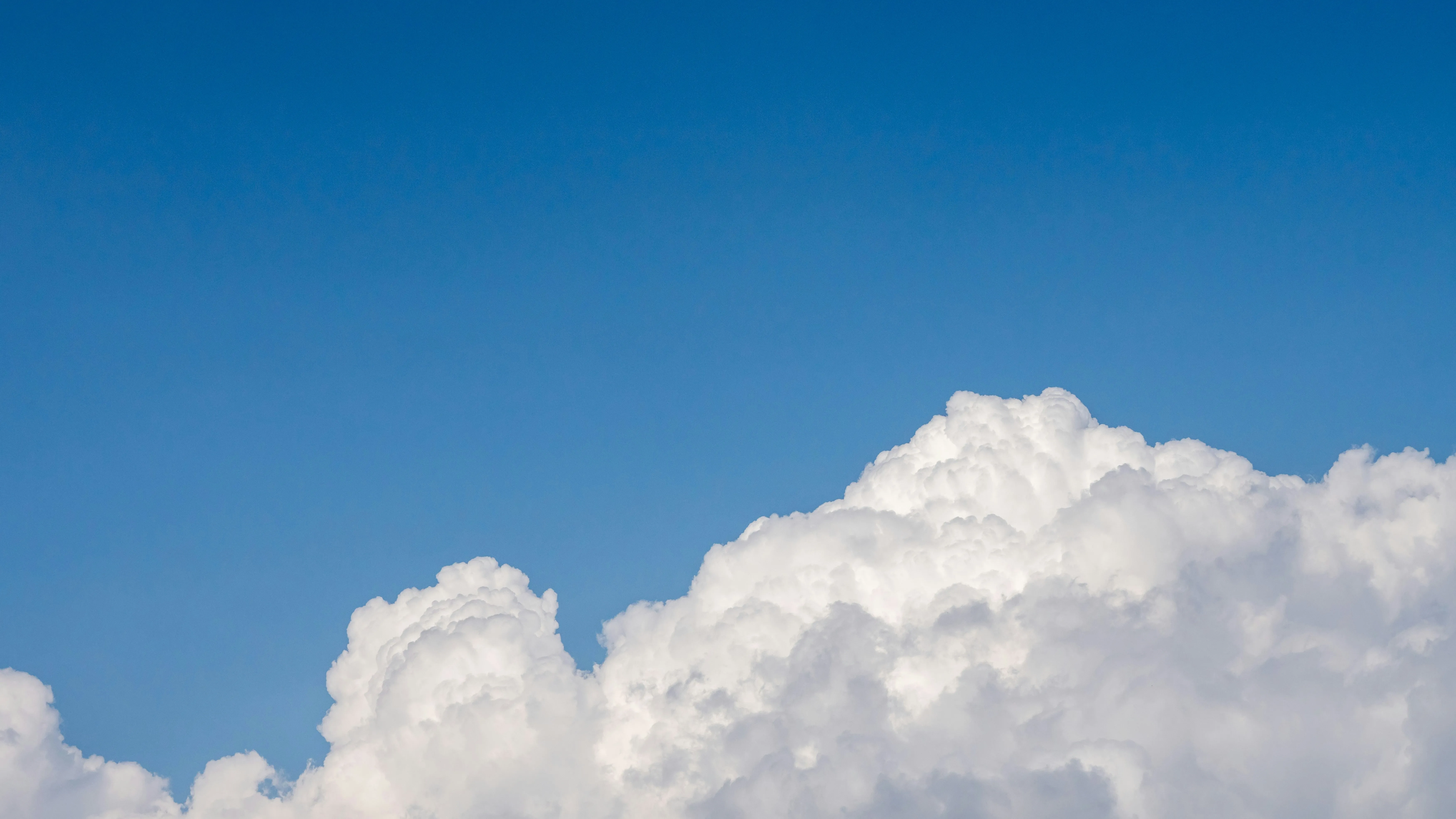 Large Cloud Floating in a Deep Clear Blue Sky Wallpaper