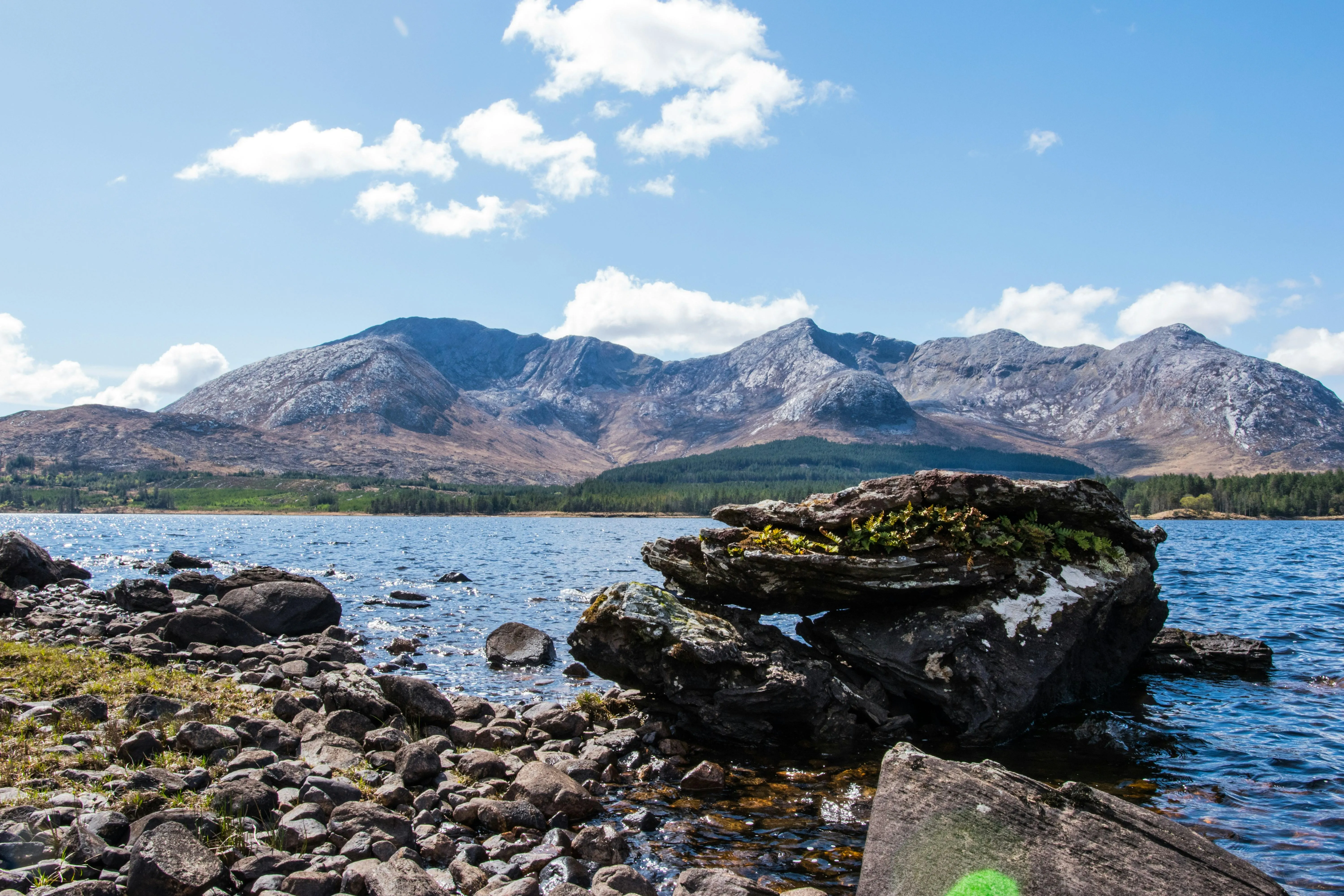 Large lake surrounded by rocky snow covered hills image