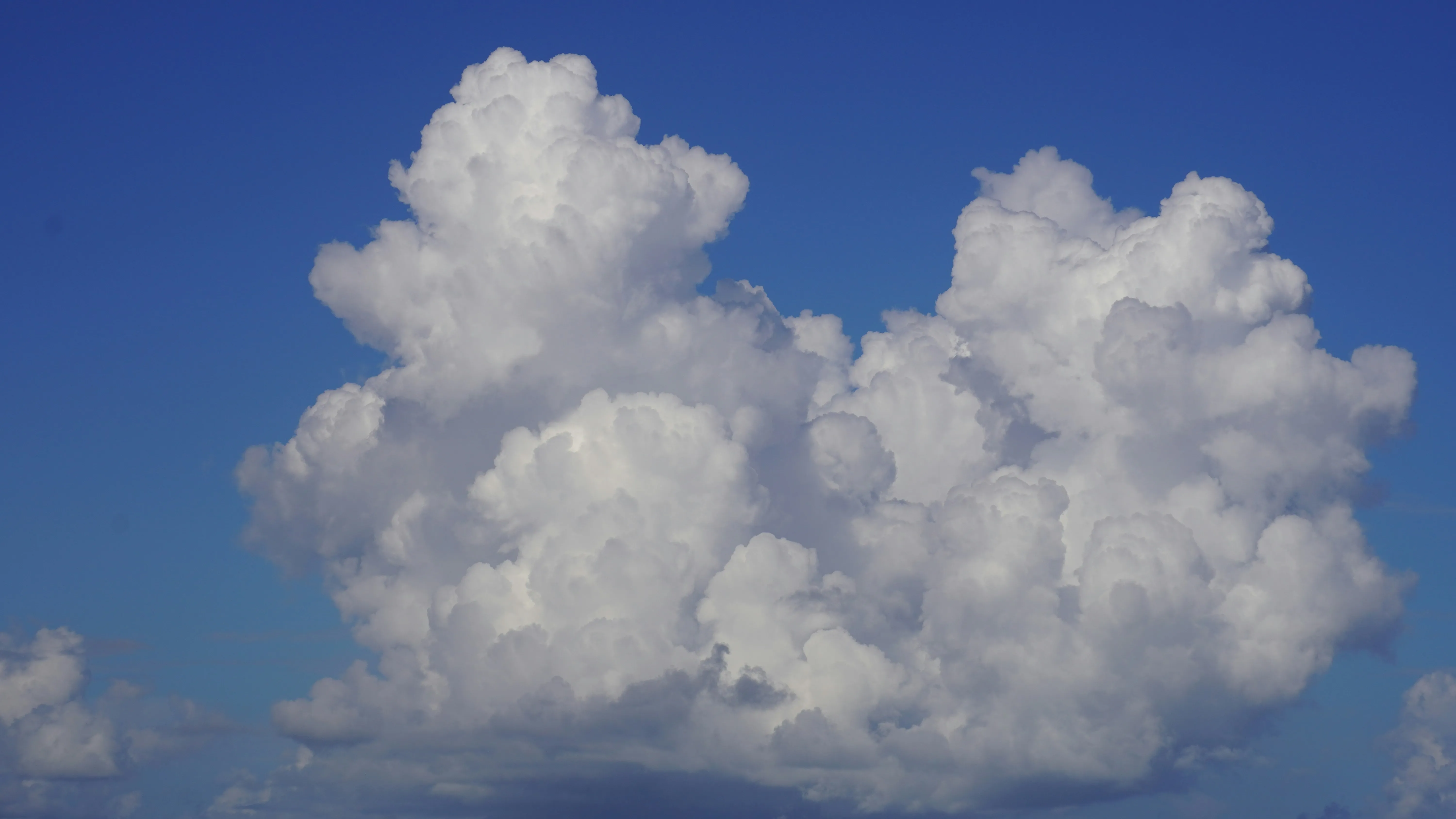 Large Puffy White Clouds in Deep Blue Sky on Sunny Day