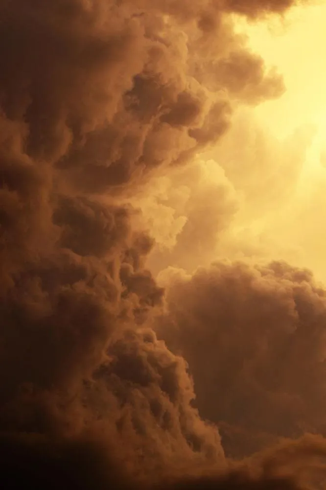 Large Storm Clouds Forming Above Dark Landscape Scene