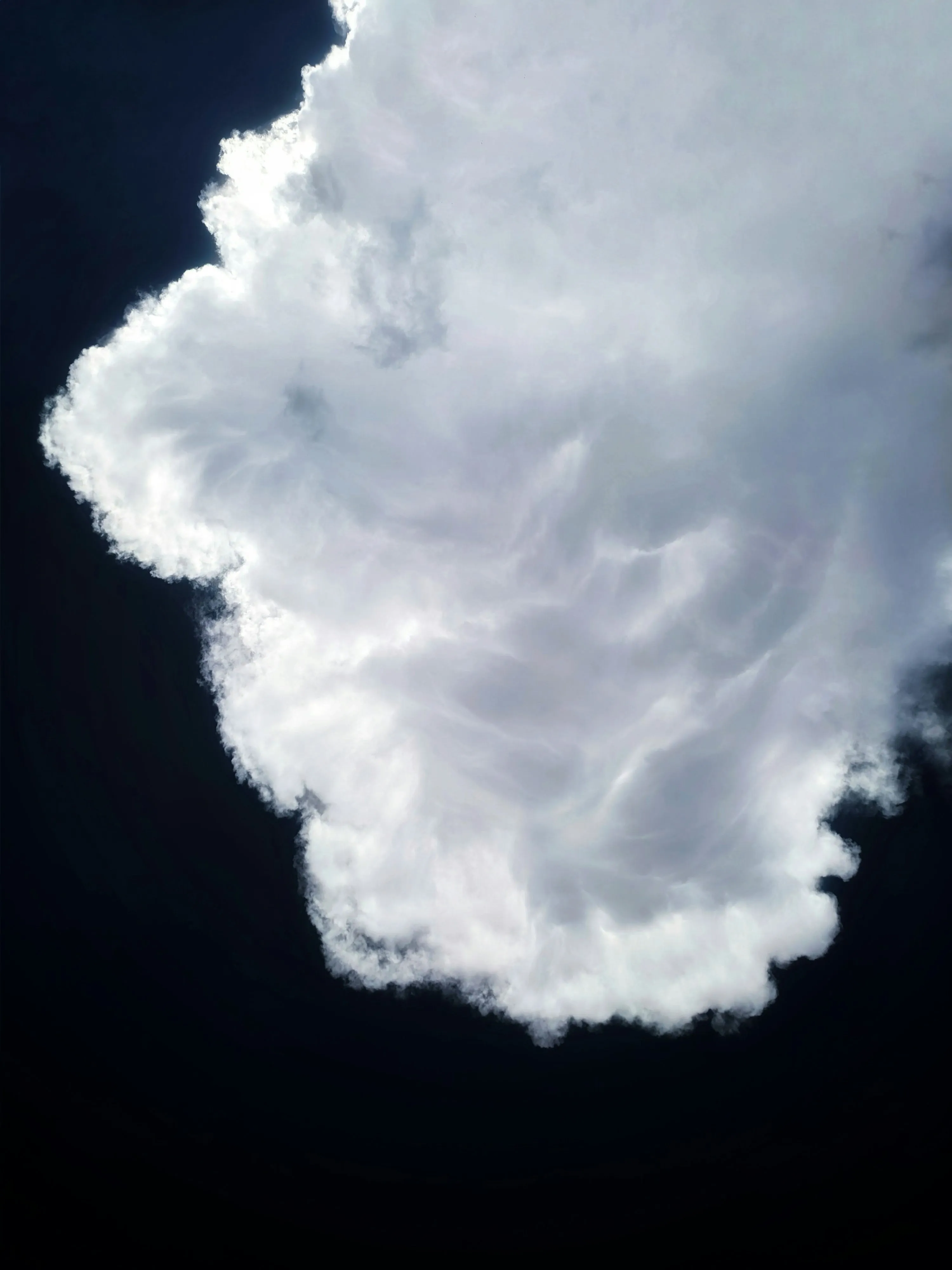 Large White Cloud Against Dark Background at Night Image