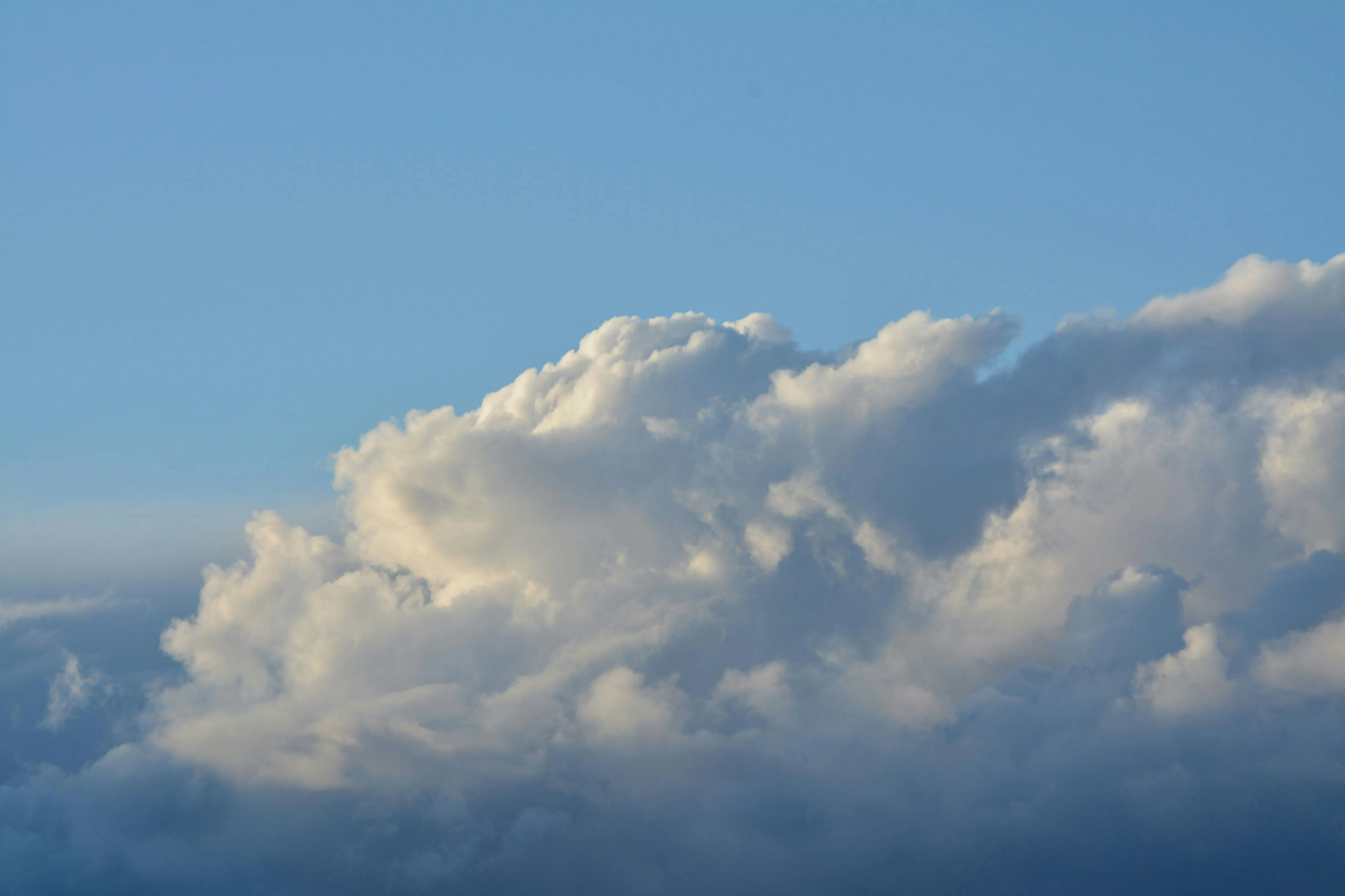 Large White Clouds Casting Shadows in a Bright Blue Sky