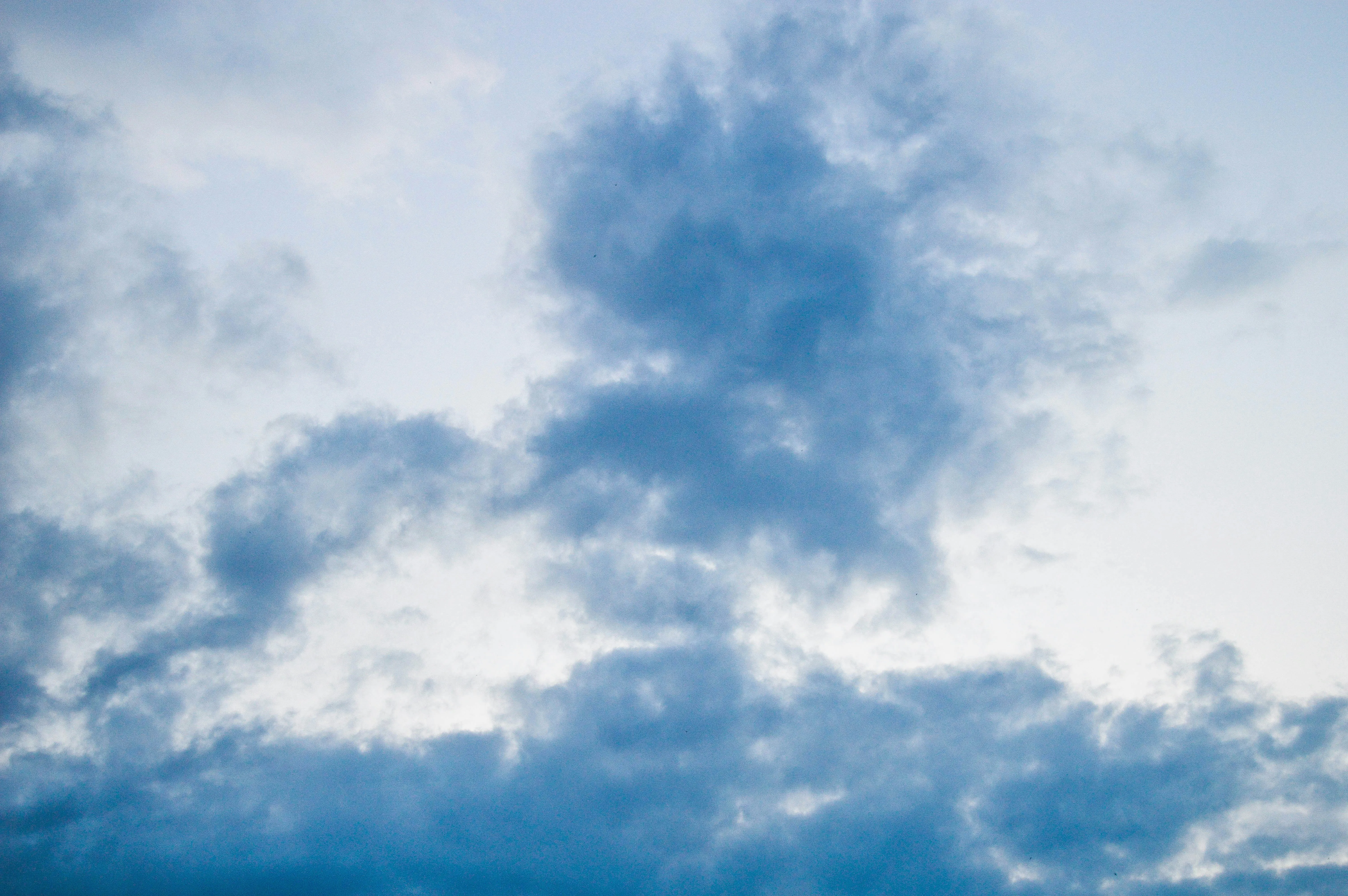 Layered Gray Clouds Forming in Blue Afternoon Sky Wallpaper